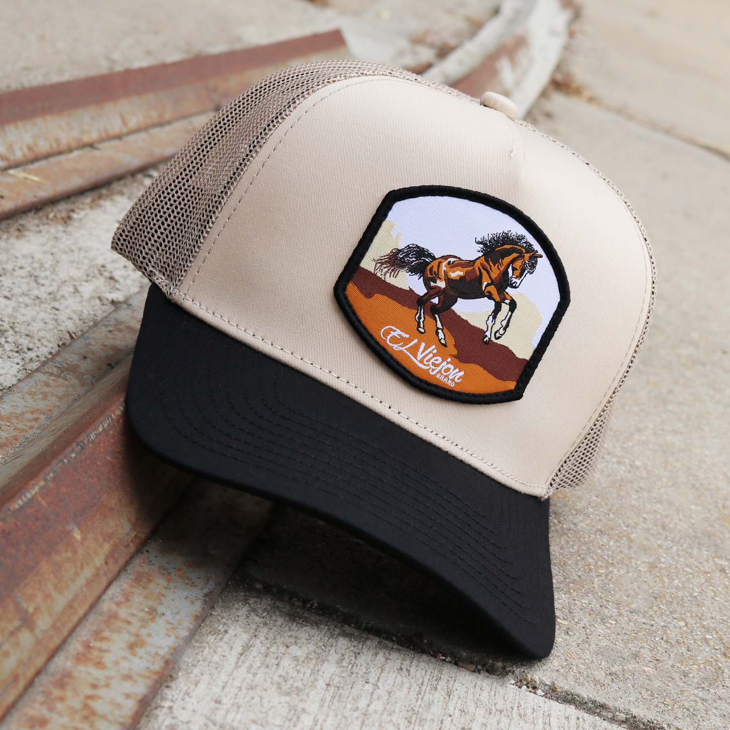 Bailador Black/Khaki AVC hat with a brown horse patch, khaki mesh, and black pre-curved visor.