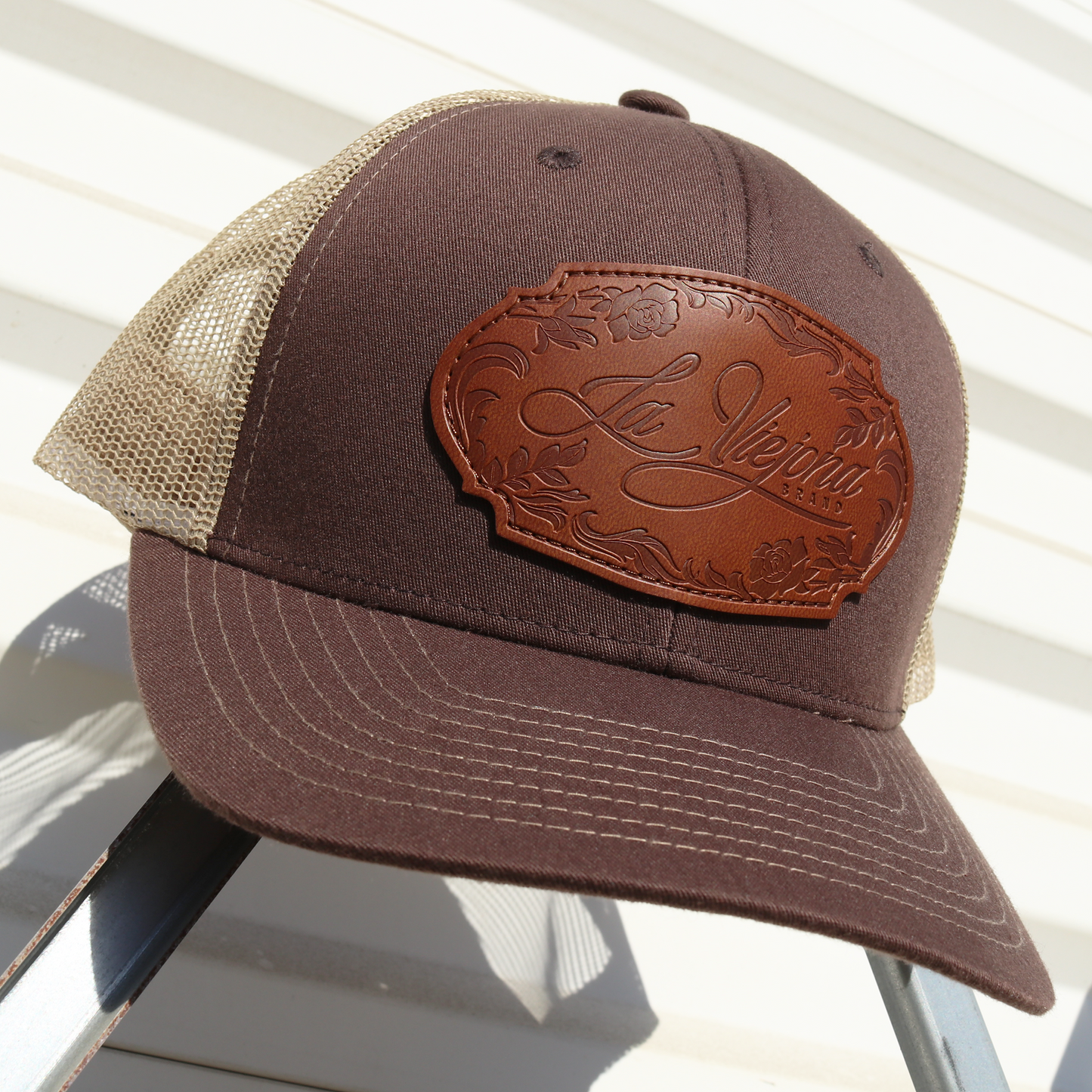 La Viejona Floral Brown/Tan Yupoong Classic trucker hat with embossed leather patch.