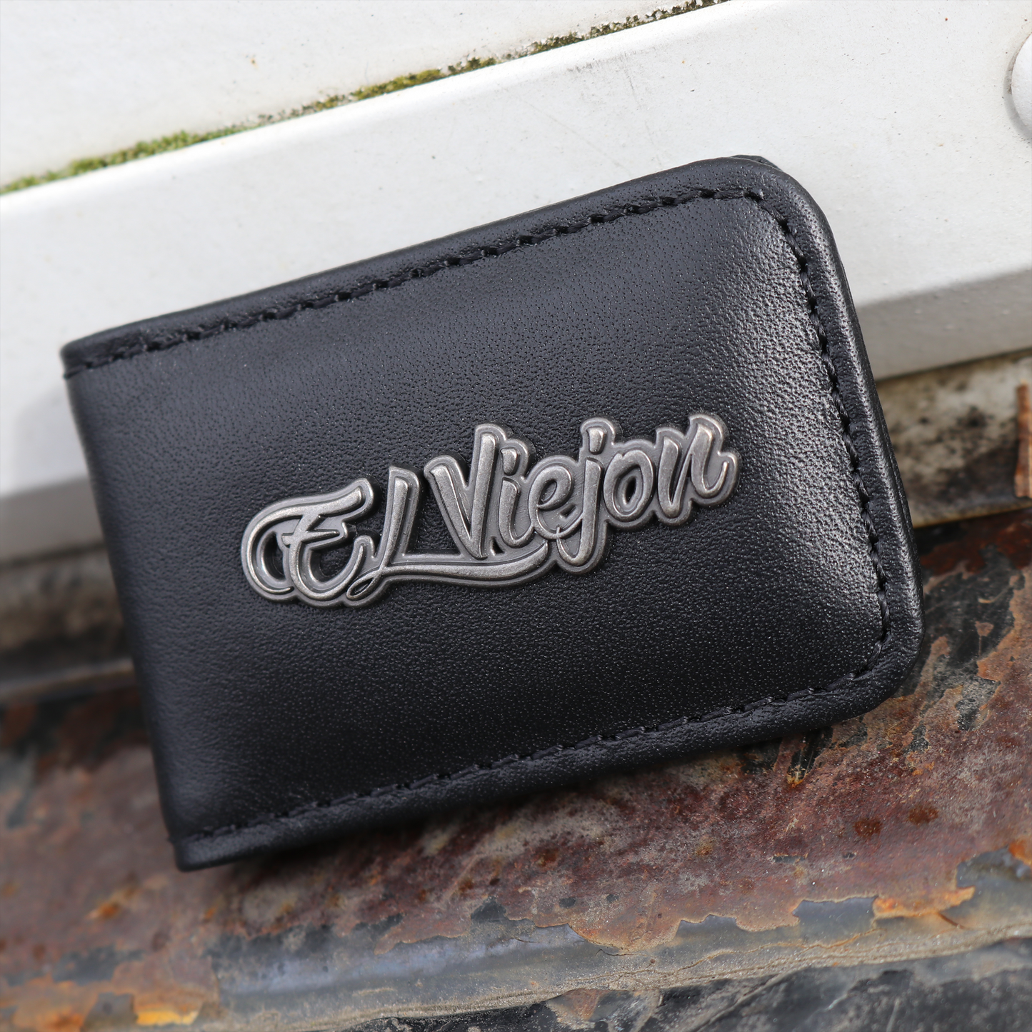 El Viejon brand black leather money clip with a metallic "El Viejon" logo.