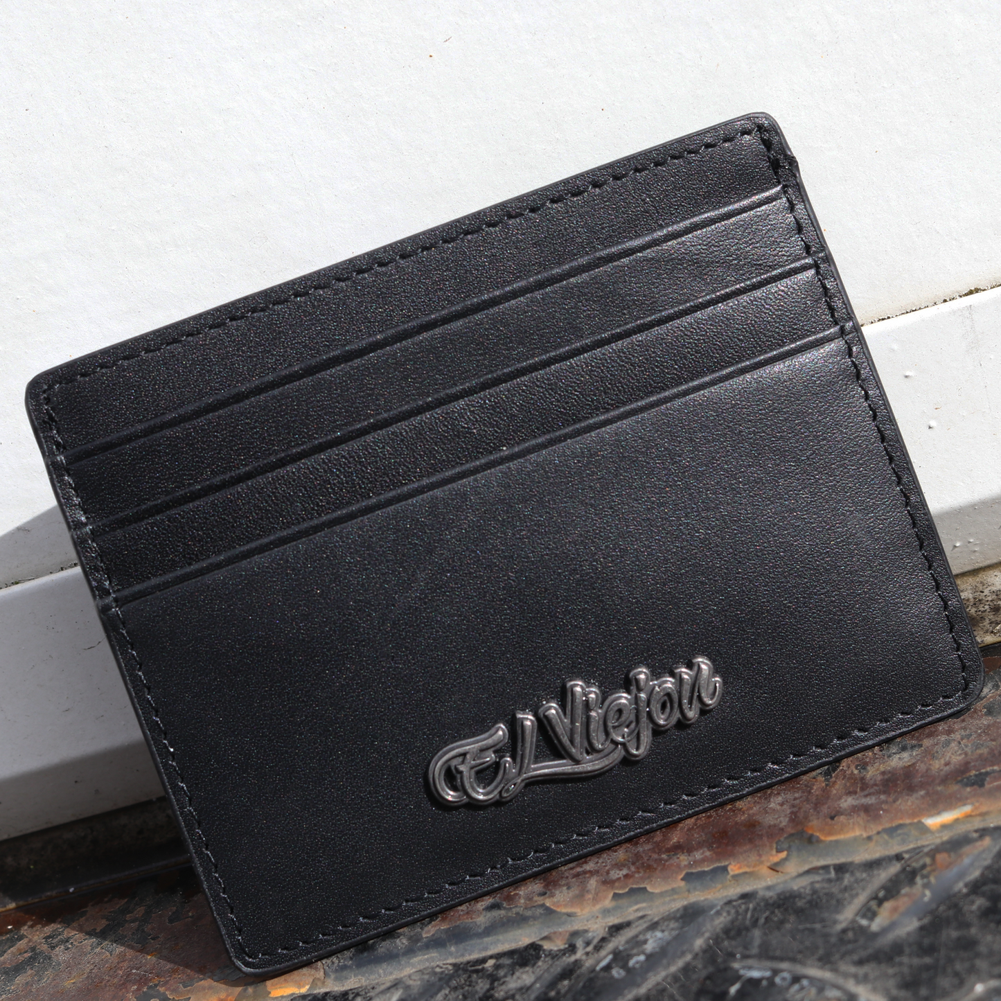 Black leather card holder with multiple slots and a metallic "El Viejon" logo.