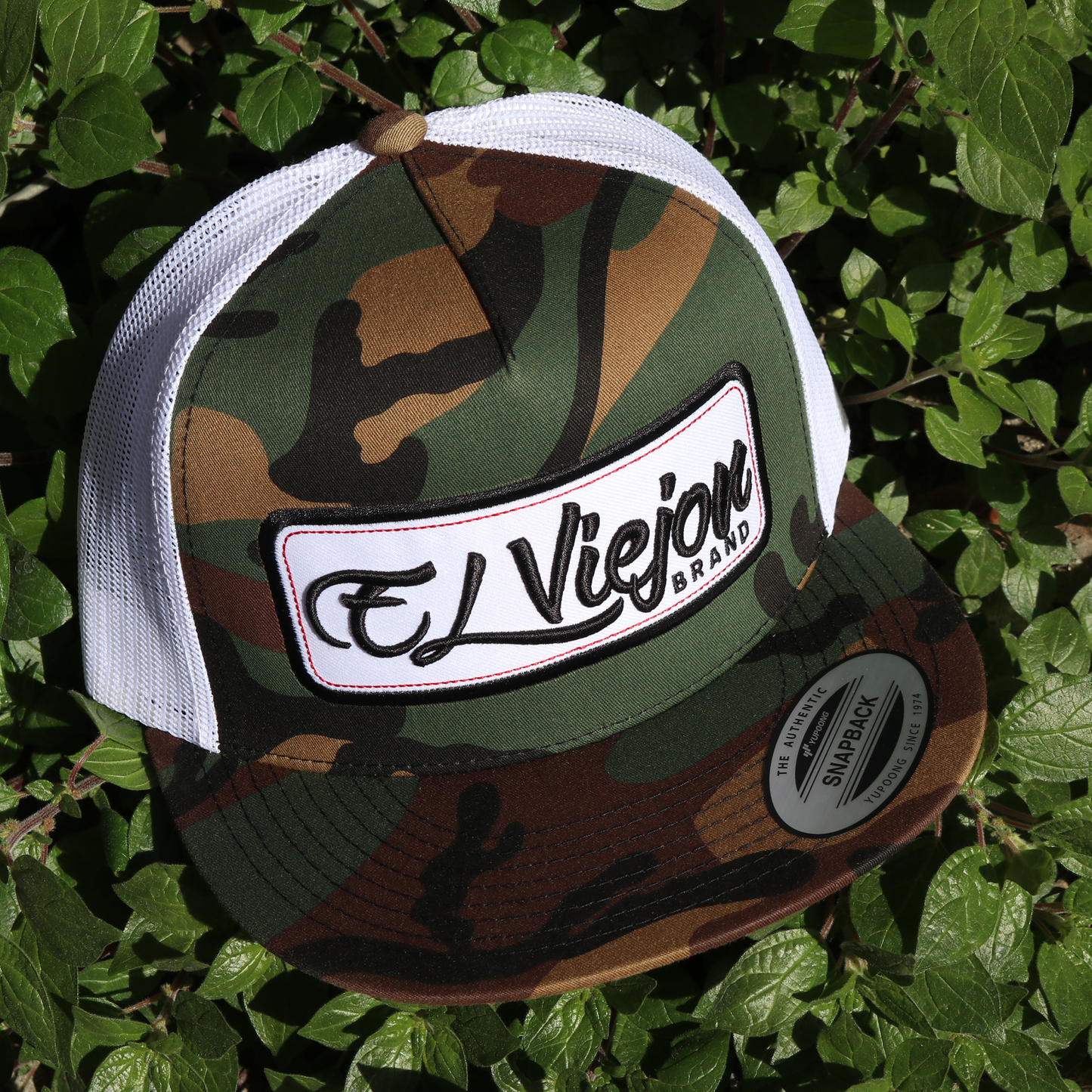 EVPatch Camo/White Yupoong Classic trucker hat with flat visor and "El Viejon Brand" patch.