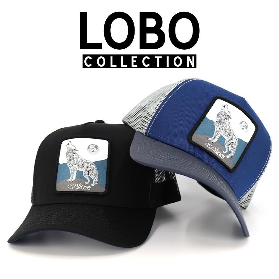 Black and blue trucker hats with howling wolf patch under a full moon.