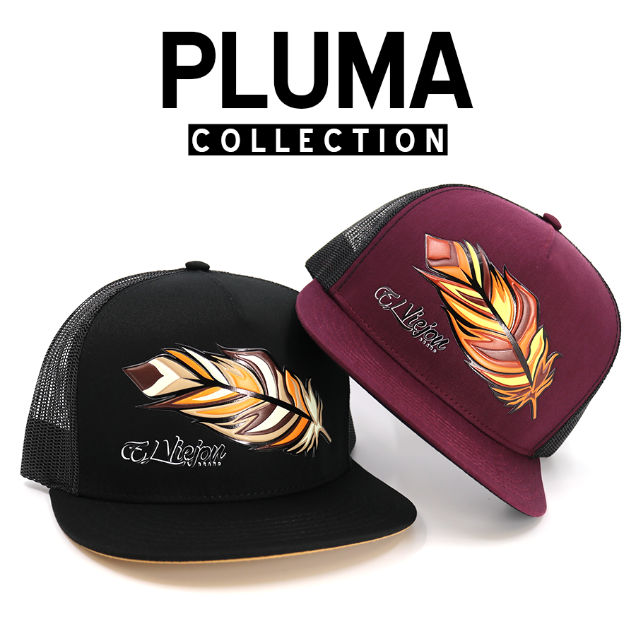 Black and burgundy trucker hats with vibrant feather embroidery, representing the Pluma Collection.
