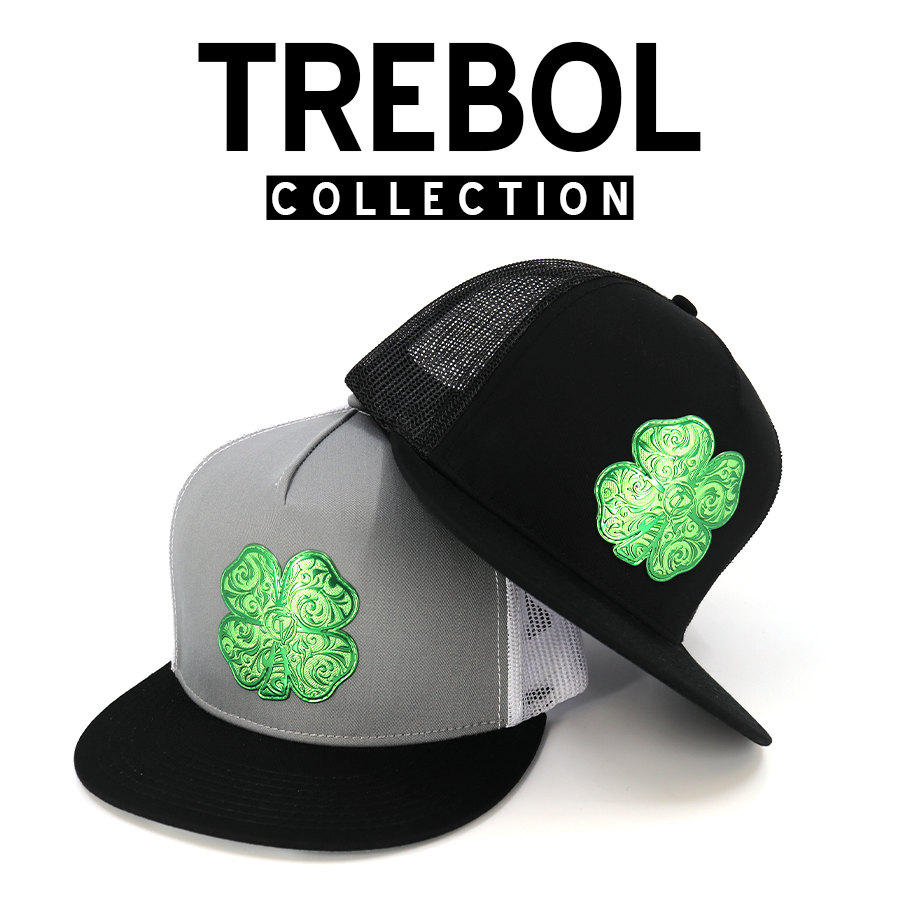 Two trucker hats, one black and one gray, featuring vibrant green embroidered four-leaf clovers.