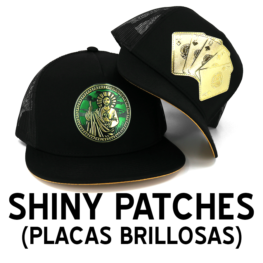 Black trucker hats with shiny gold and green metallic patches featuring religious and poker card designs.