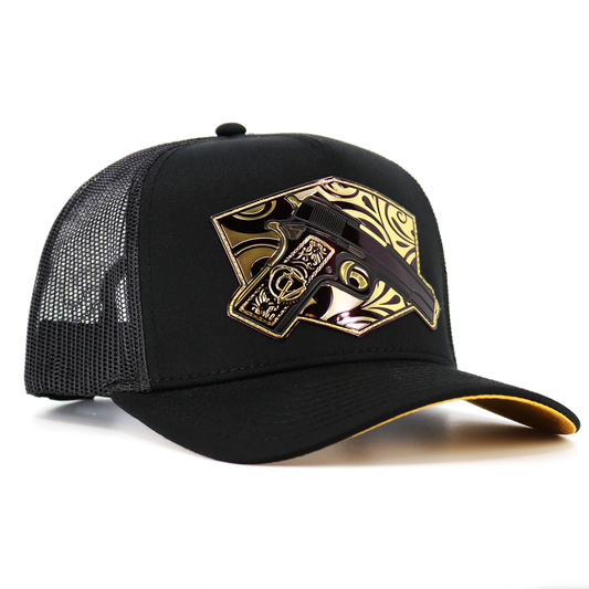 Cachas de Oro Black AVC hat with gold gun emblem, black mesh, and pre-curved visor.
