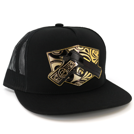Cachas De Oro Black flat visor trucker hat with gold gun emblem.