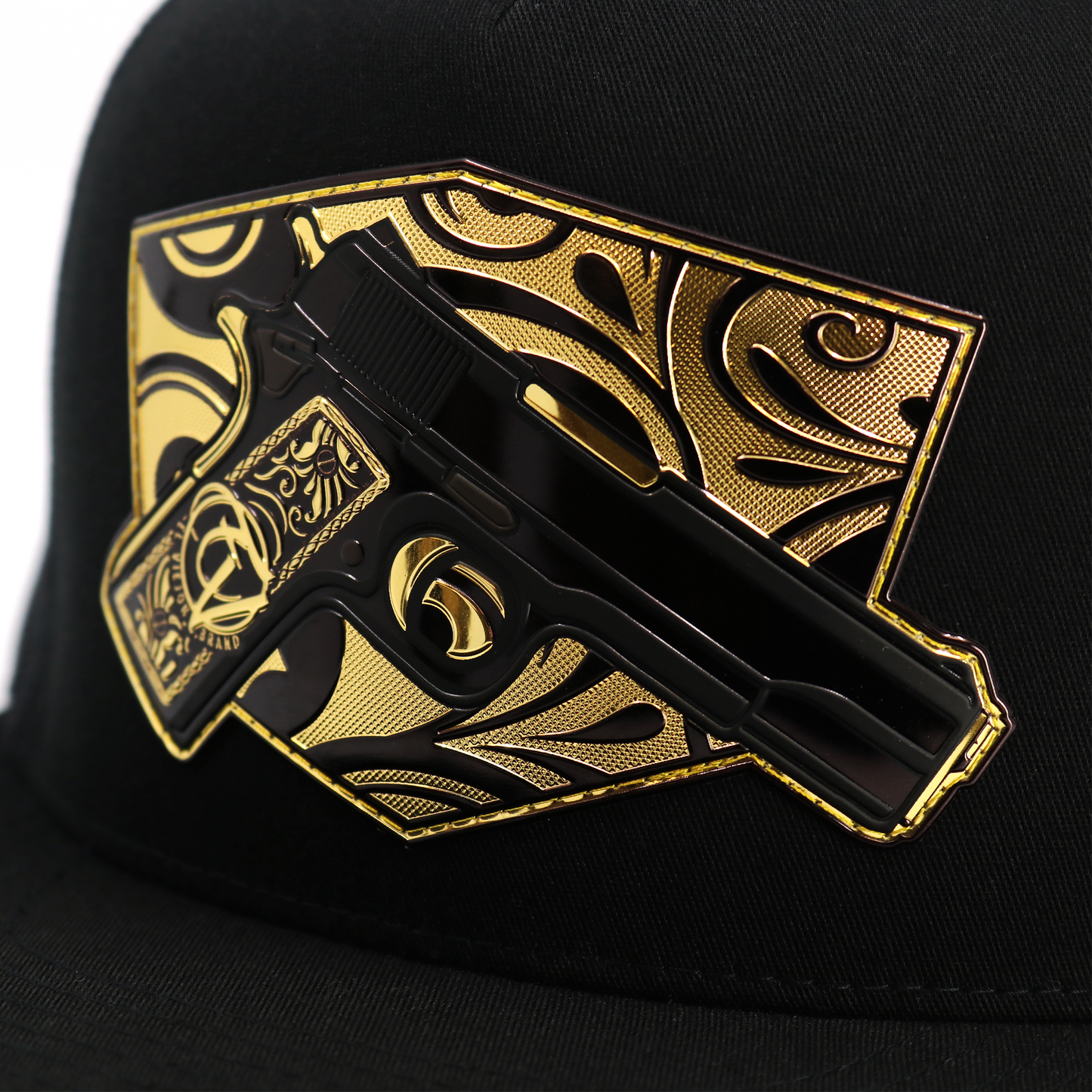 Cachas De Oro Black flat visor hat with a gold and black gun-shaped emblem.