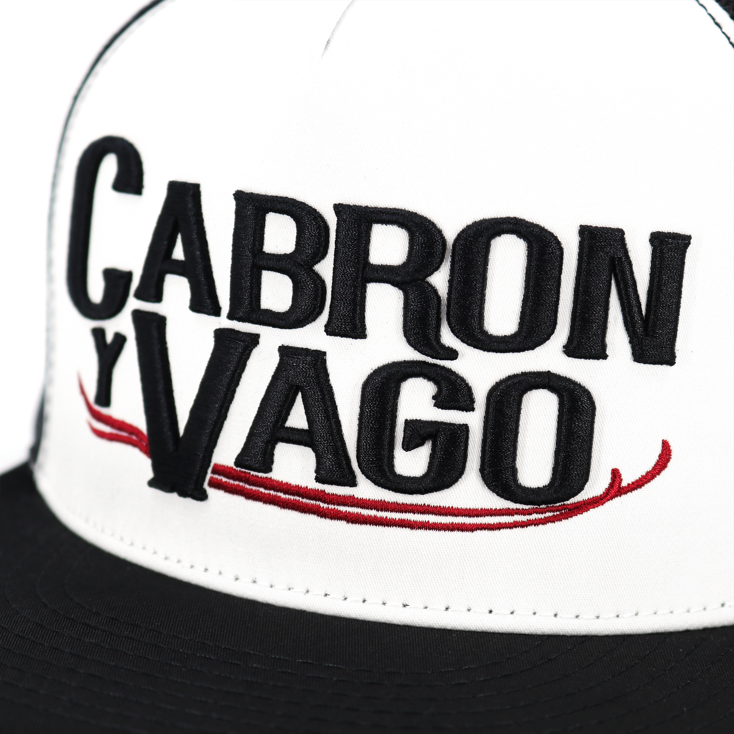 Cabron Y Vago Black/White/Black flat visor hat with embroidered logo and adjustable snapback.