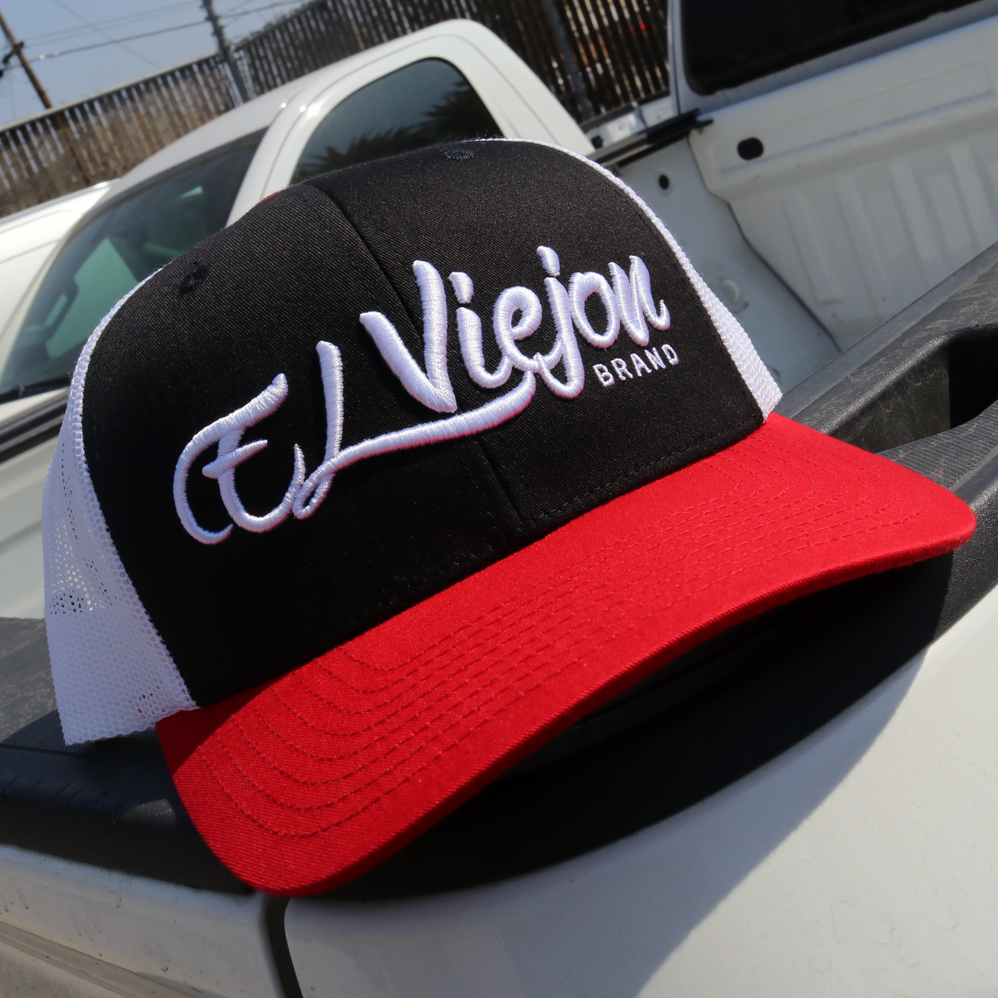 La Original Red/Black/White classic visor hat with "El Viejon Brand" embroidered, mesh back, and pre-curved visor.