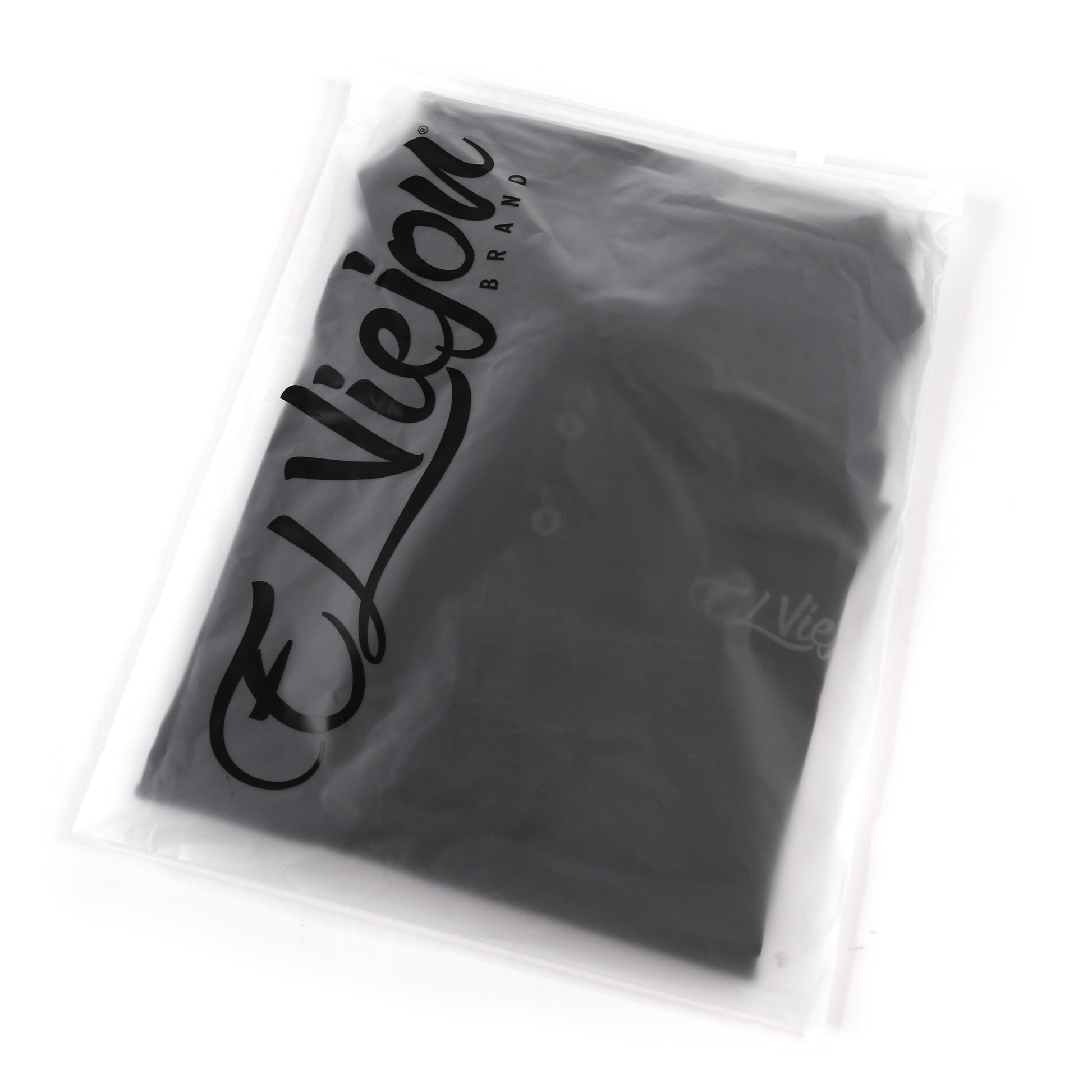 Black polo shirt with charcoal El Viejon Brand logo, folded in clear plastic packaging.