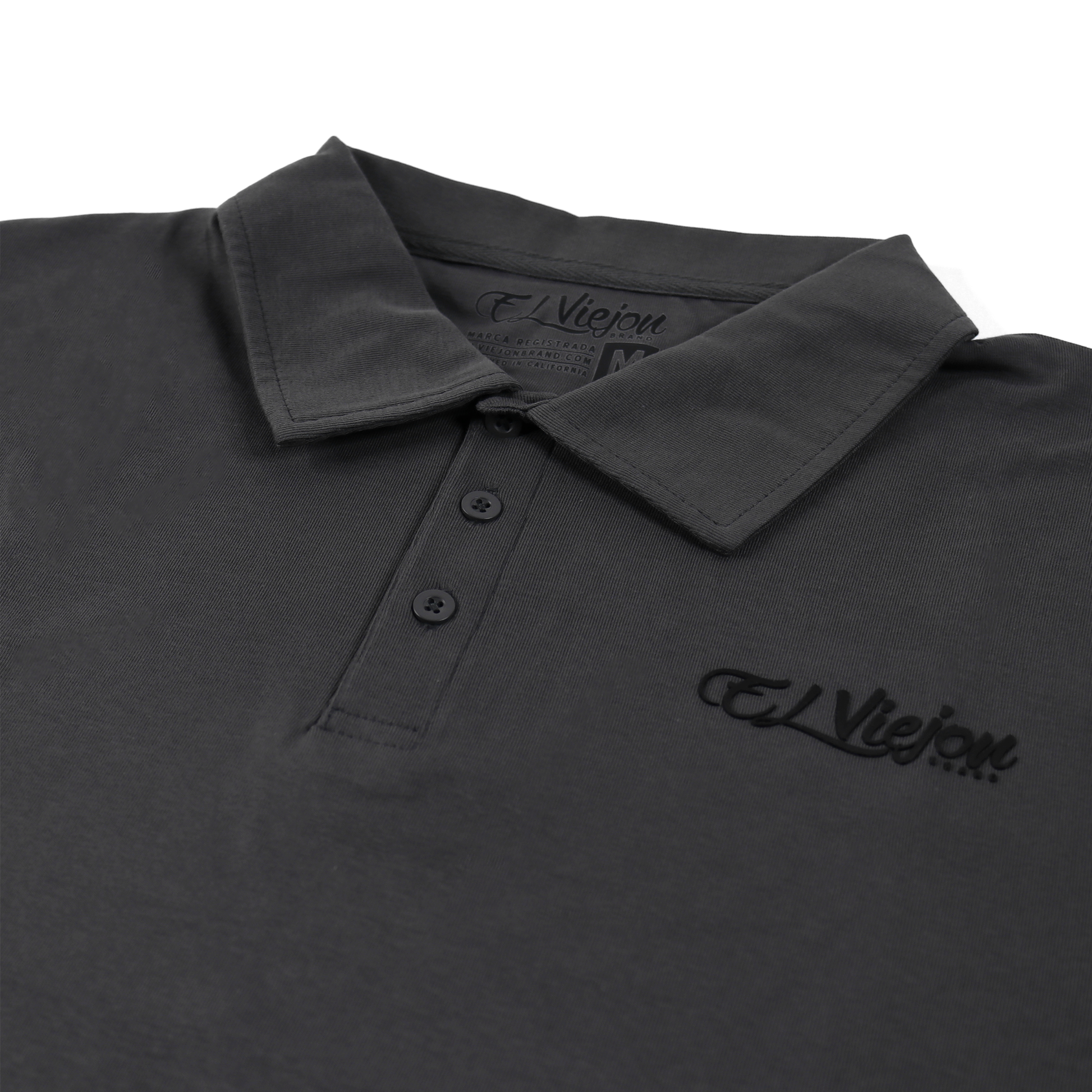Charcoal polo shirt with 3-button placket and 3D vinyl "El Viejon Brand" logo.