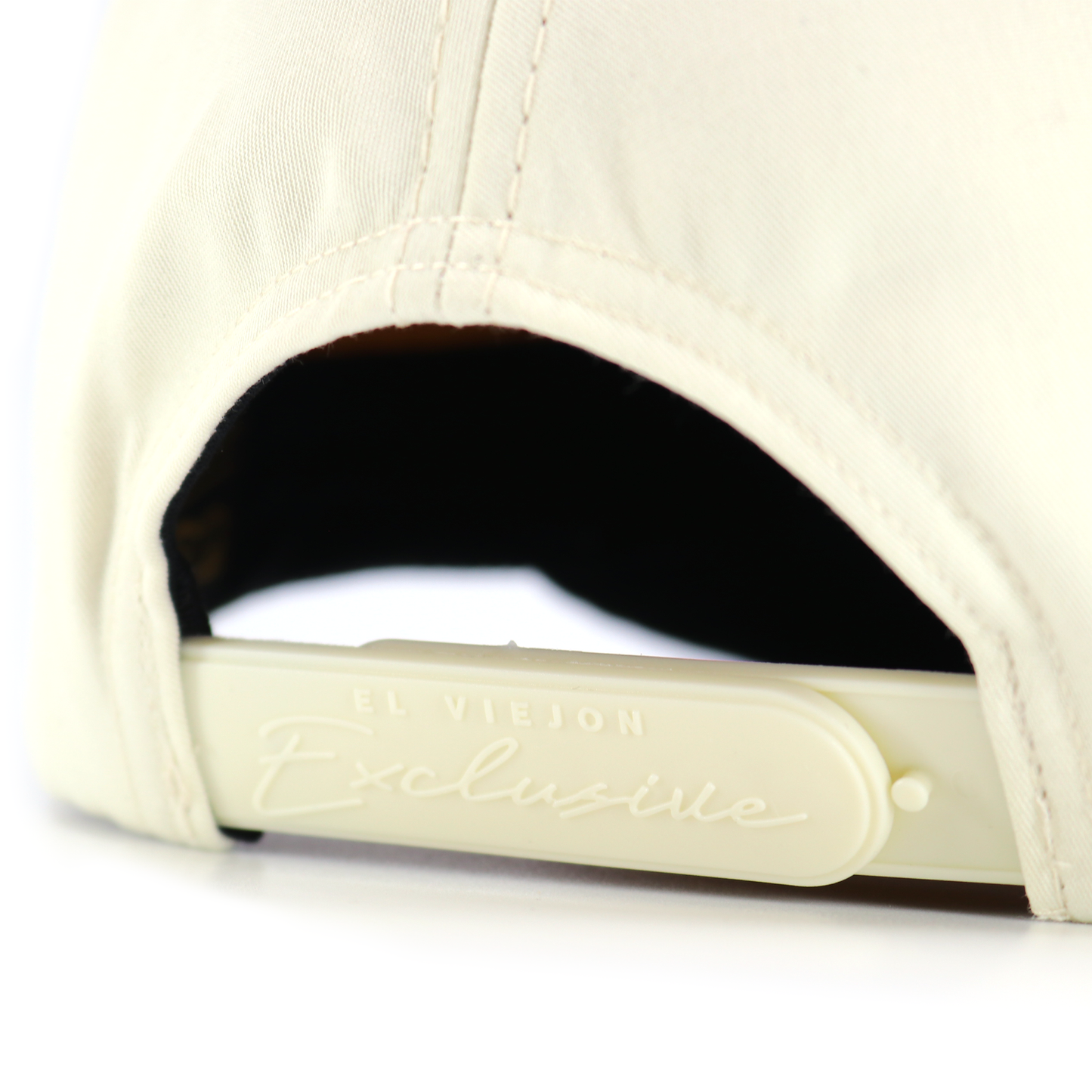 Close-up of a beige cap with a brand logo on a white background