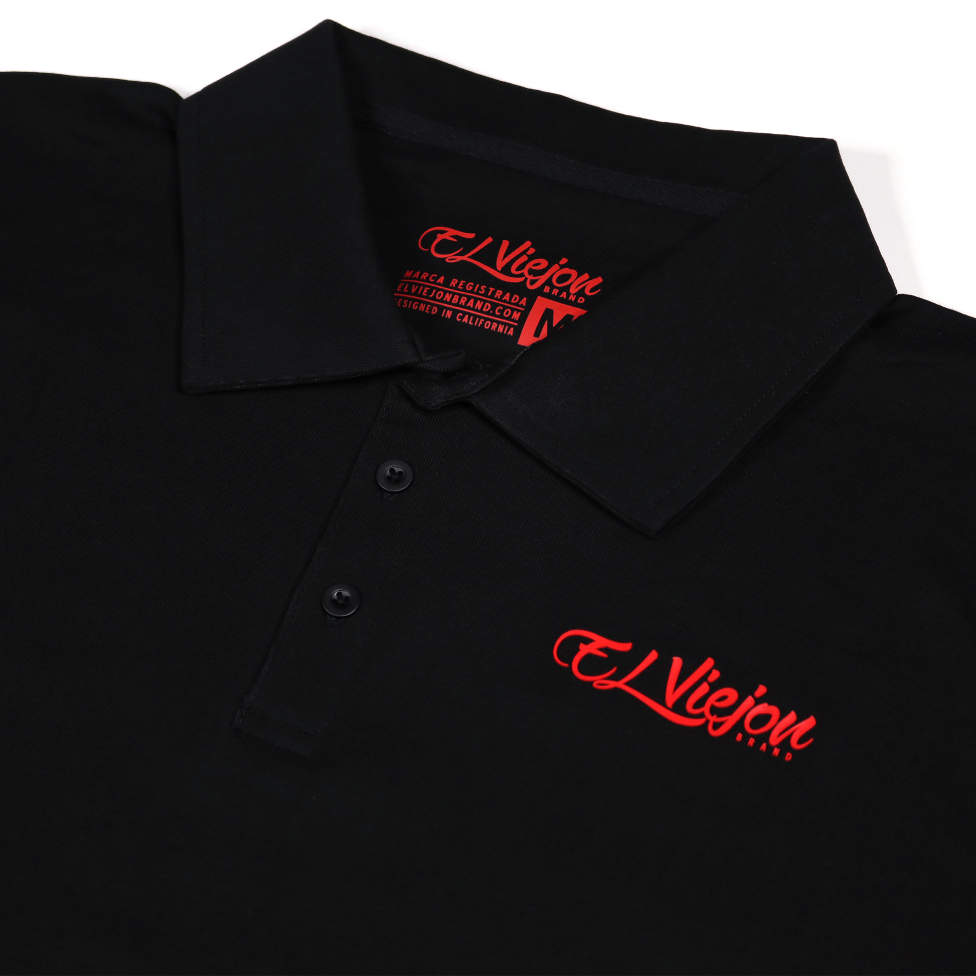Black polo shirt with red "El Viejon Brand" 3D vinyl logo, 3-button placket, and collared neck.