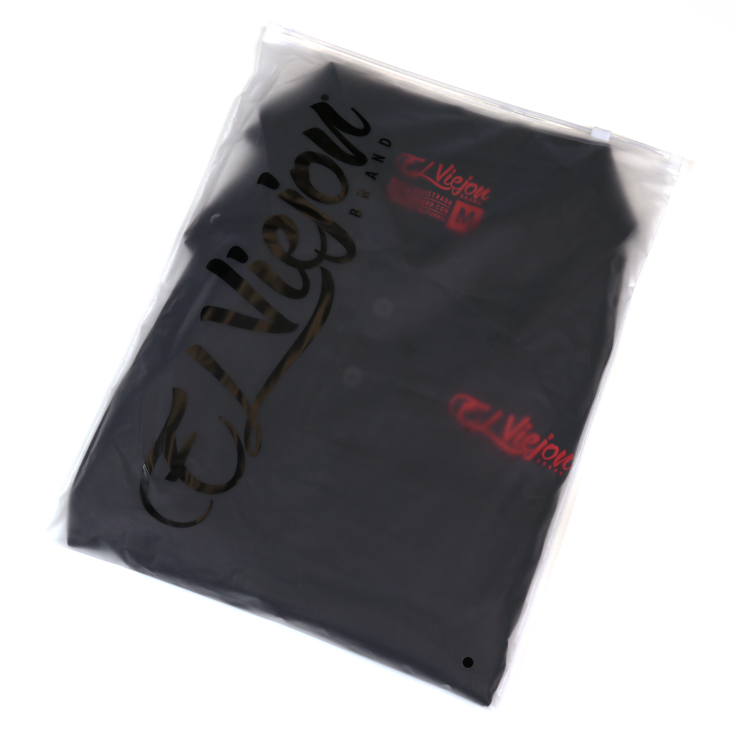 Black Polo Shirt with red El Viejon Brand logo, packaged in a clear plastic bag.