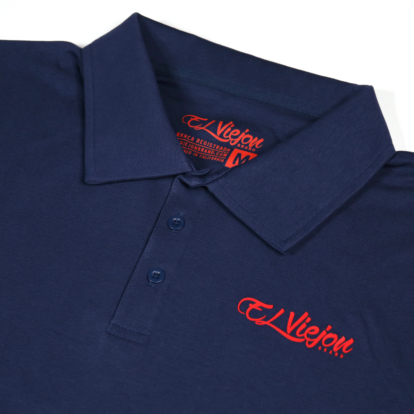 Navy blue polo shirt with a 3-button placket and red 3D "El Viejon Brand" logo.