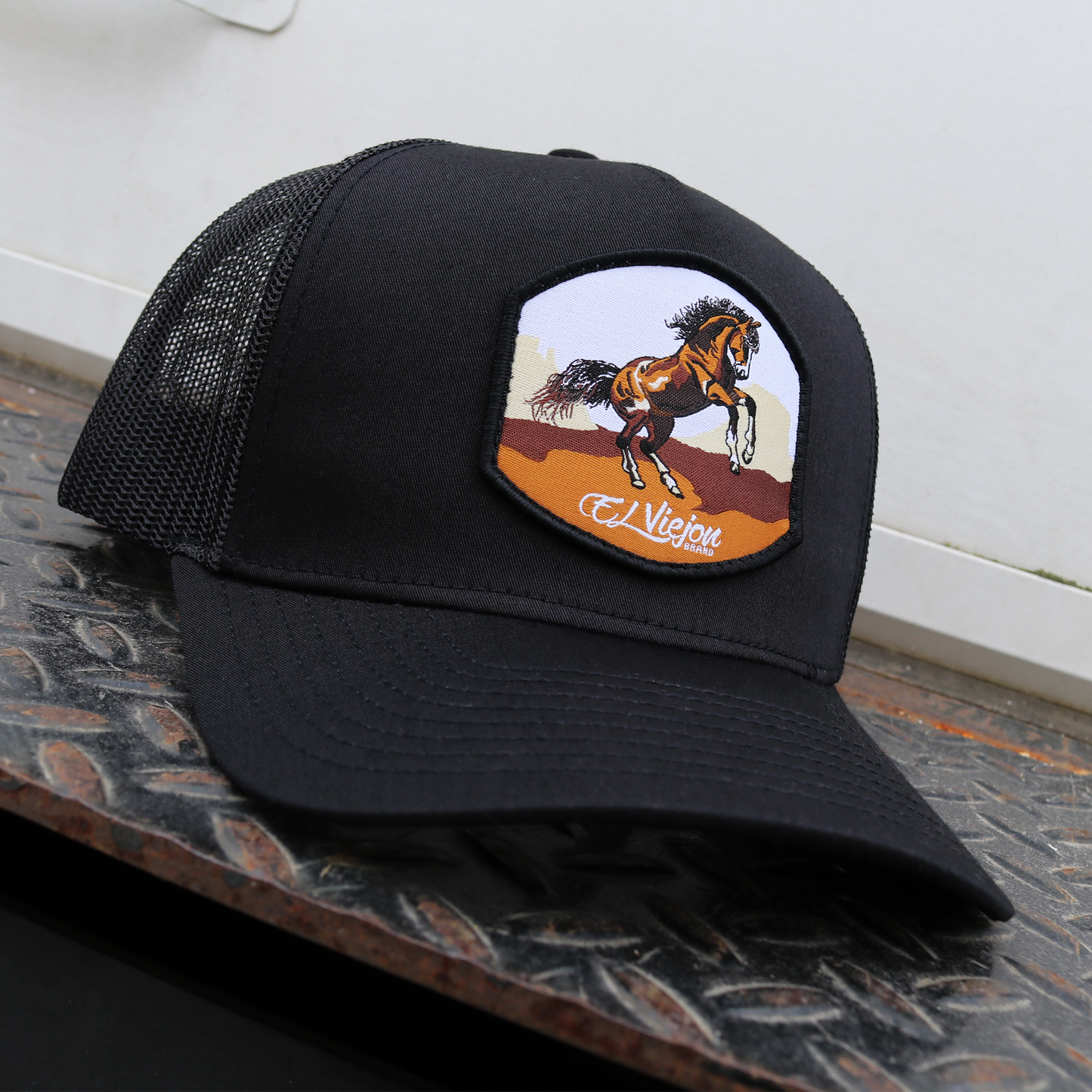 Bailador Black AVC hat with black mesh, pre-curved visor, and a horse graphic patch.