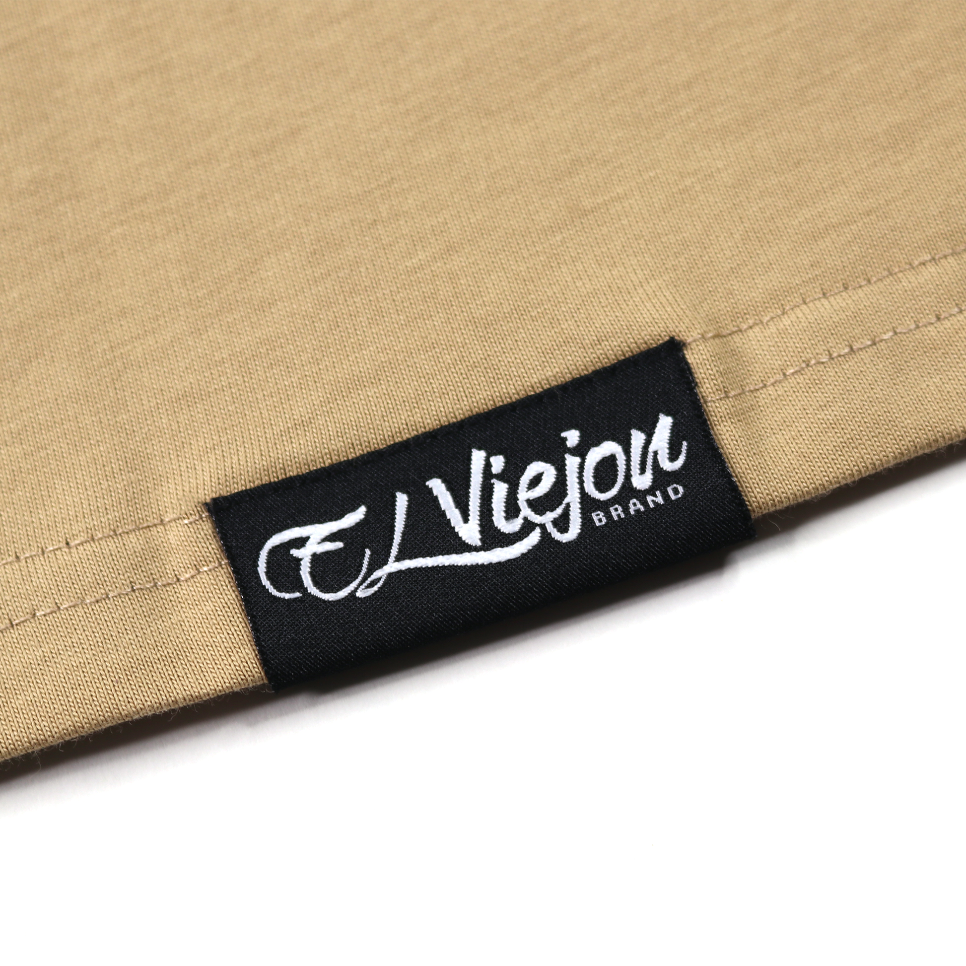 Close-up of a khaki 100% cotton Euro Shirt with a black "El Viejon Brand" woven label.