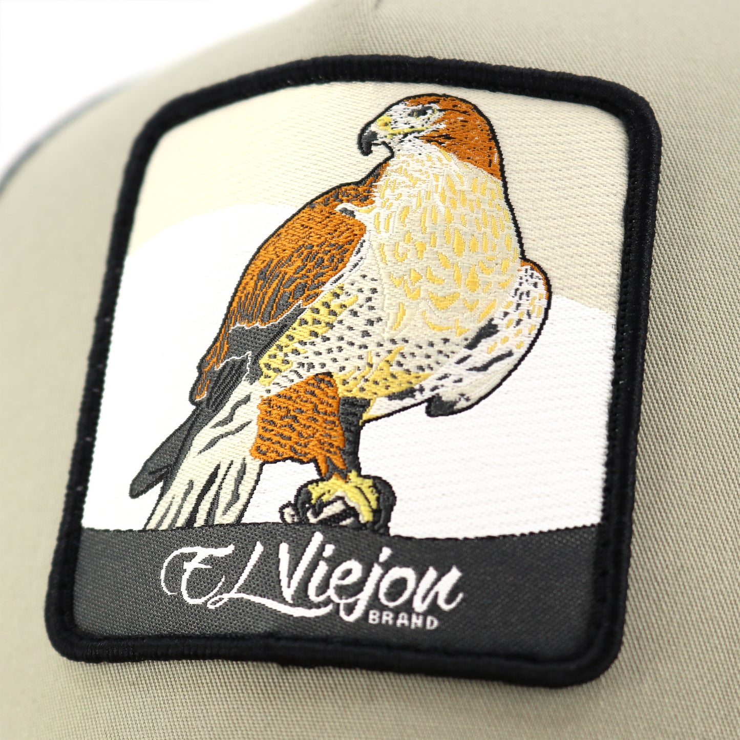 Halcon Camel/Tope/Black AVC hat with embroidered falcon patch and "El Viejou Brand" text.