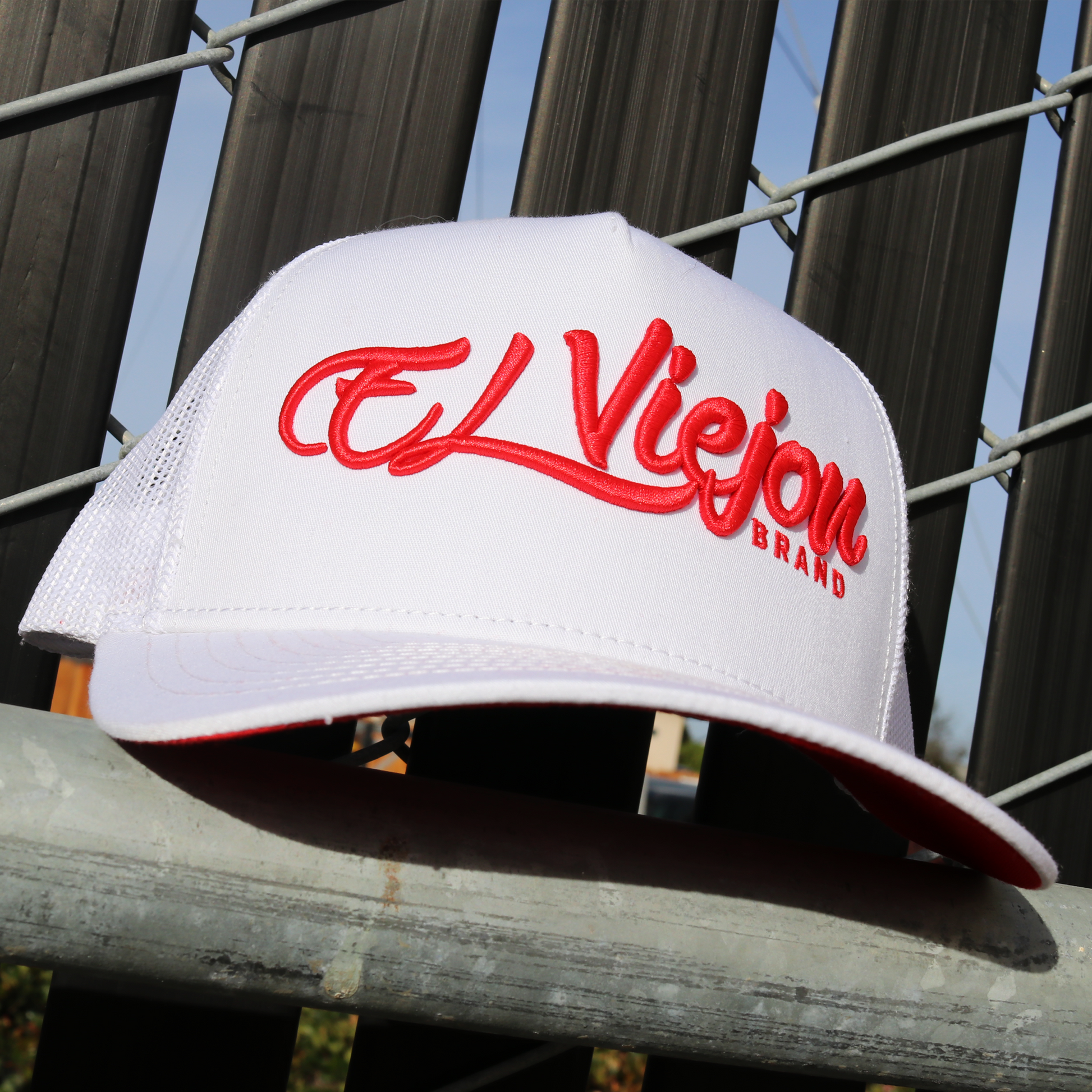 White La Original AVC hat with red "El Viejon Brand" embroidery, white mesh back, and pre-curved visor.