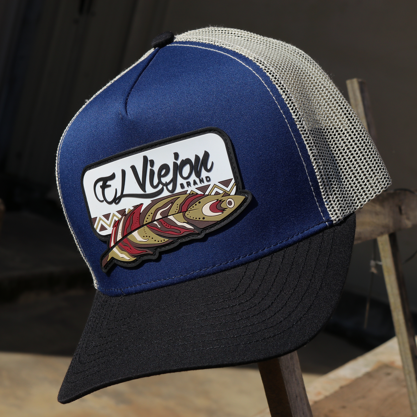 Nativo Black/Blue/Cream AVC hat with "El Viejou Brand" feather patch, blue front, black visor, and cream mesh.