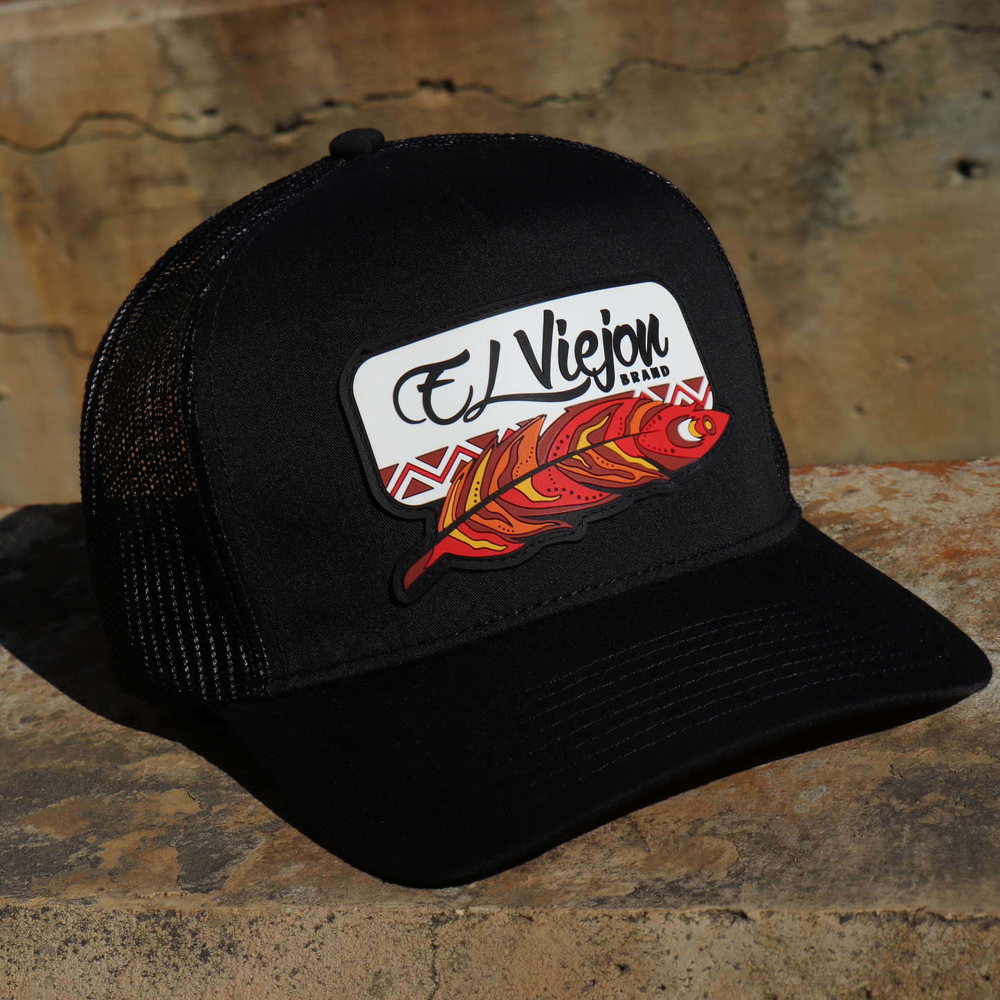 Nativo Black AVC hat with black mesh, pre-curved visor, and "El Viejou Brand" feather patch.