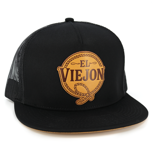 Rienda Black flat visor hat with black mesh back and brown "El Viejon" leather patch.