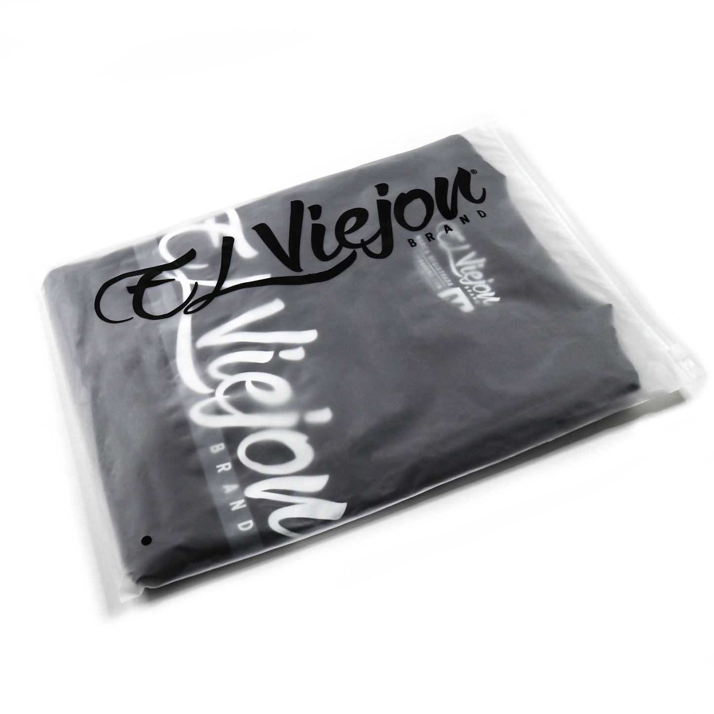 Black Alpha Shirt by El Viejon Brand, folded in clear plastic packaging with logo.