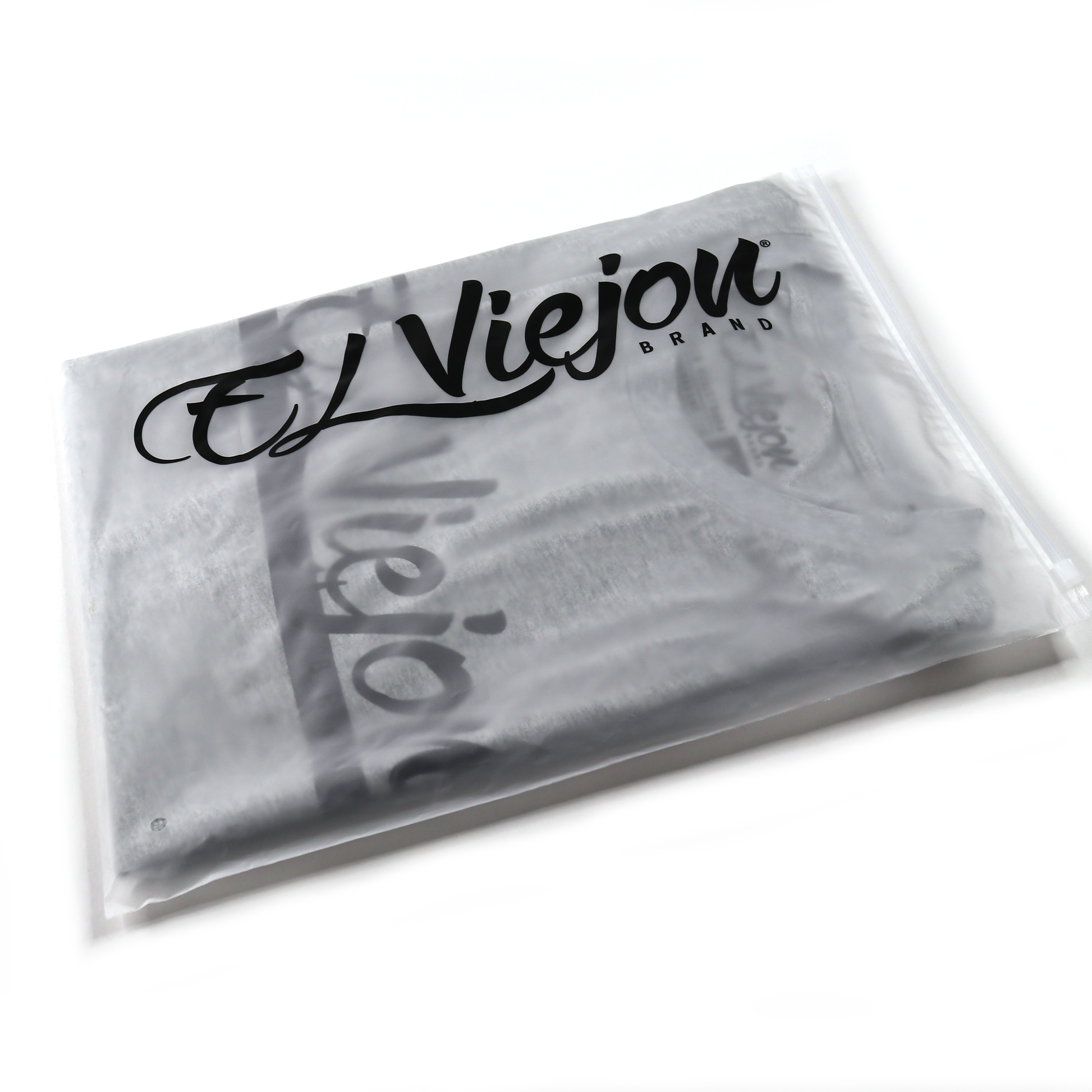 Alpha Shirt heather gris, folded in clear plastic packaging with "El Viejou Brand" logo.