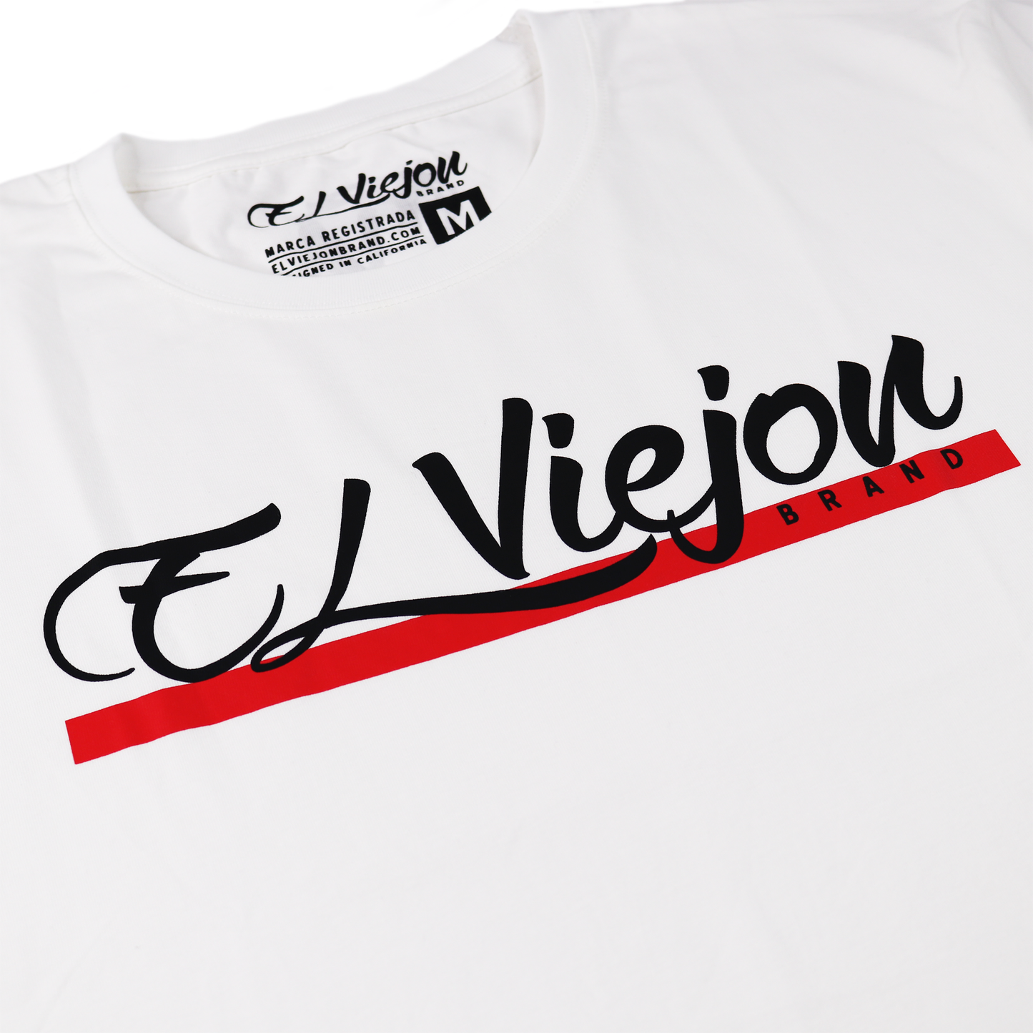 White 100% cotton Alpha shirt with black and red "El Viejon Brand" screen-printed logo.