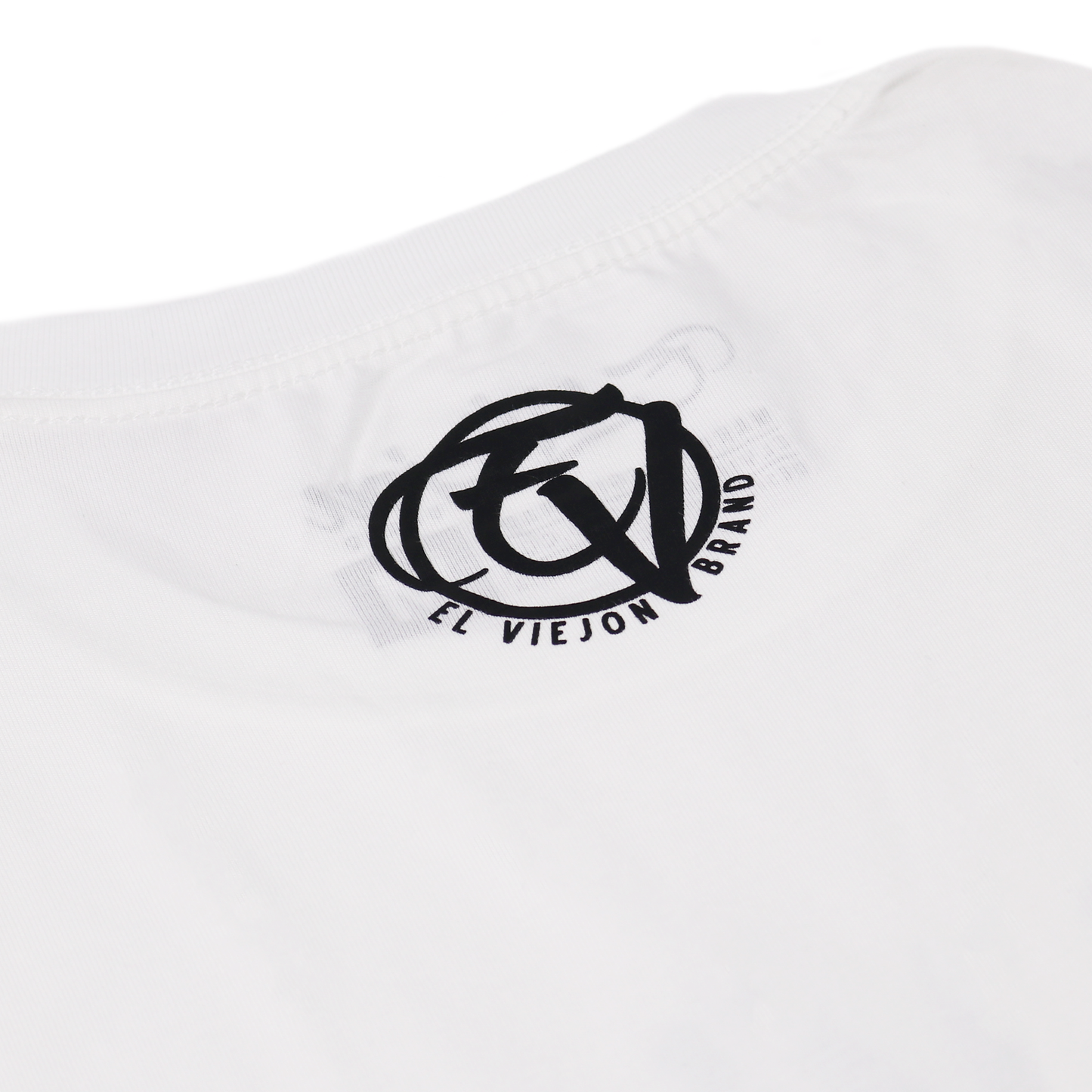 White 100% cotton Alpha Shirt with black screen-printed "El Viejon Brand" logo on the back collar.