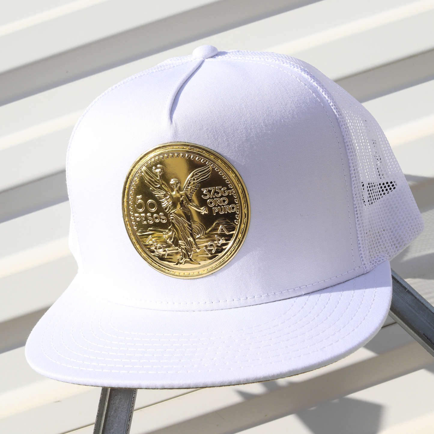 El Cente White Yupoong Classic trucker hat with a gold coin emblem.