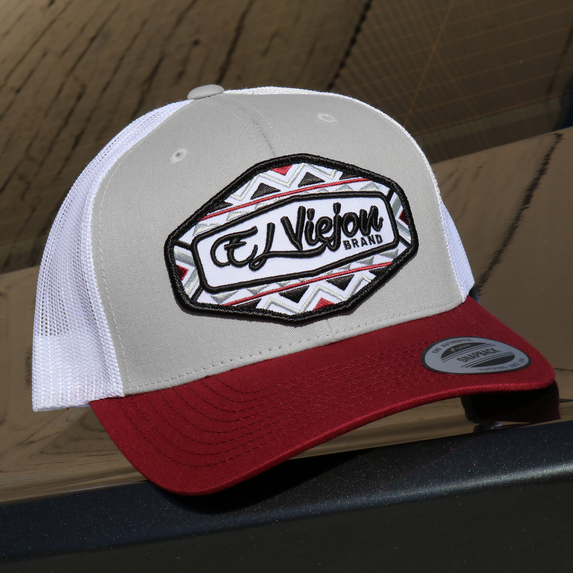 Dakota maroon/silver/white Yupoong Classic trucker hat with "El Viejon Brand" patch, mesh back, and snapback.