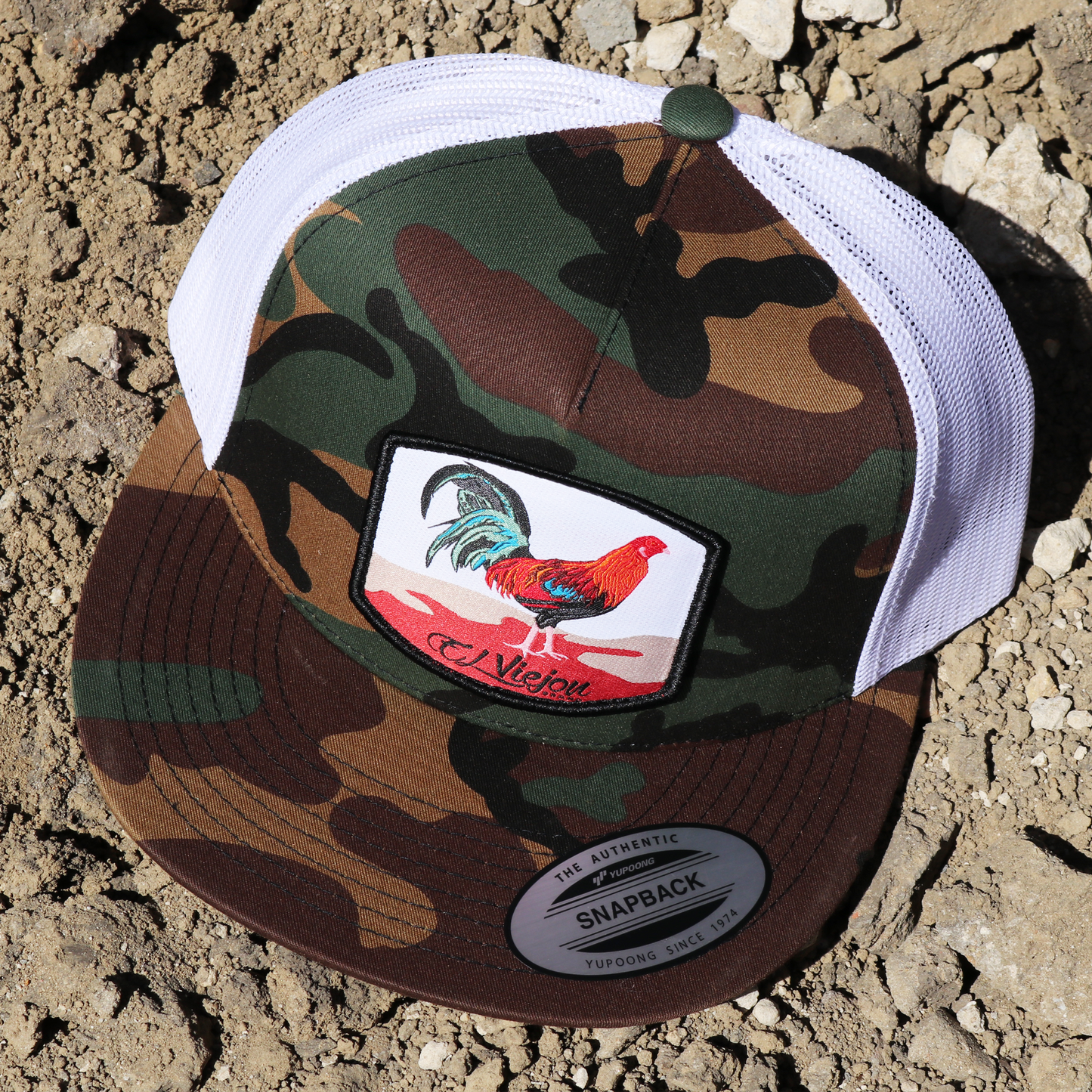 Gallo Camo/White Yupoong trucker hat with flat visor and rooster patch.