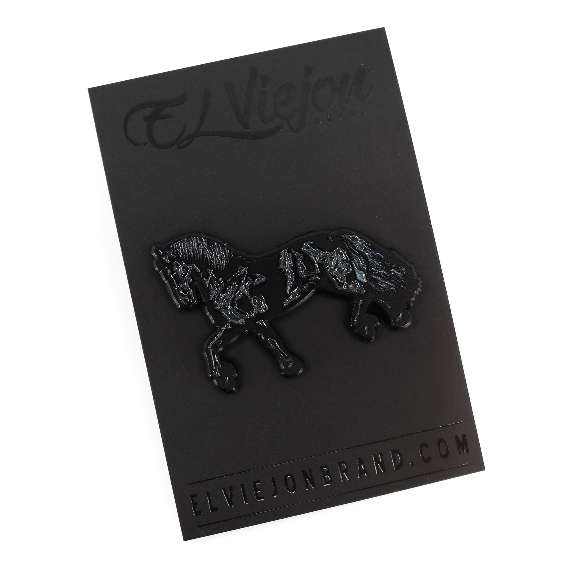 Black Frison horse enamel pin with rubber clutch on a black branded card.
