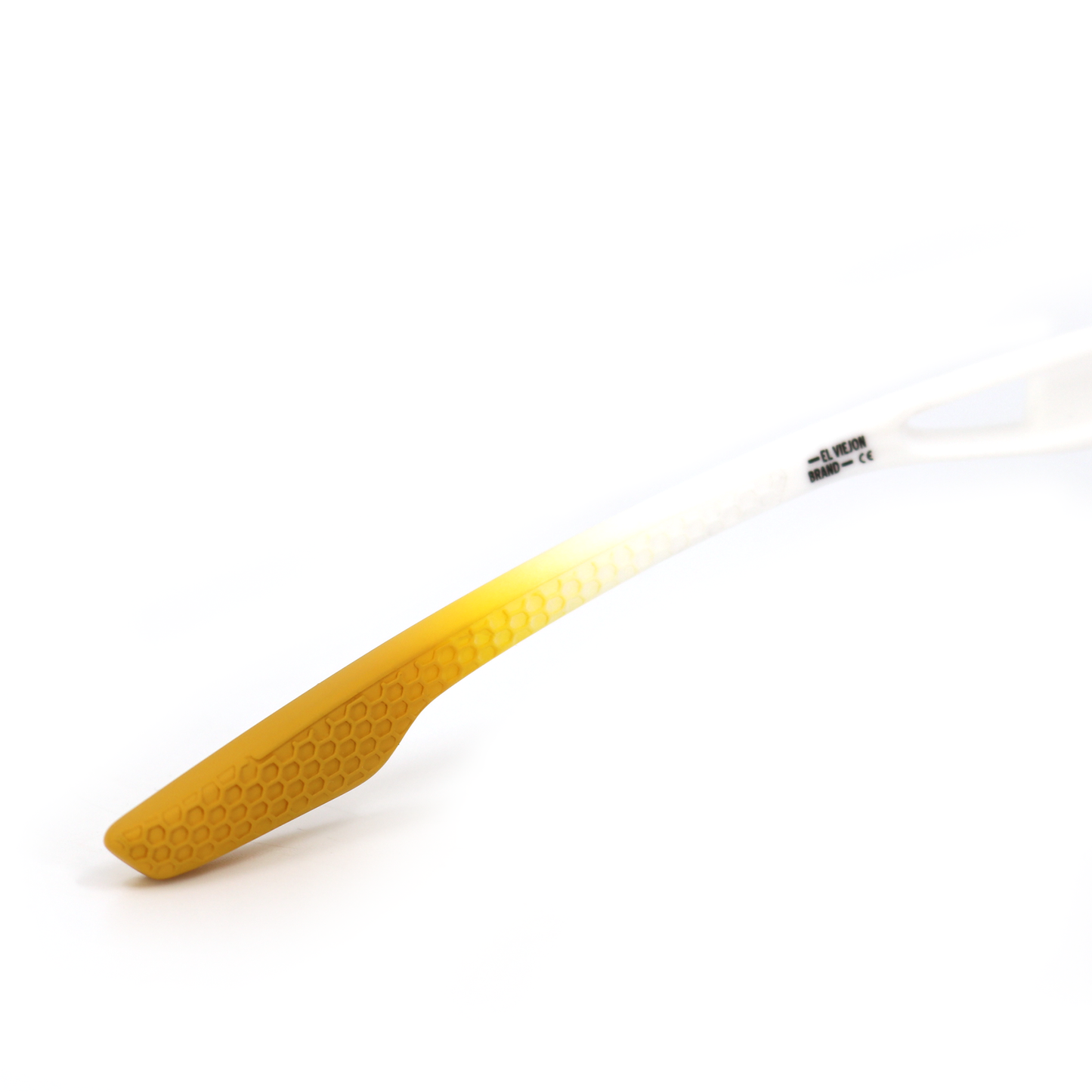 White El Viejon Brand sunglasses temple with gold honeycomb textured tip.