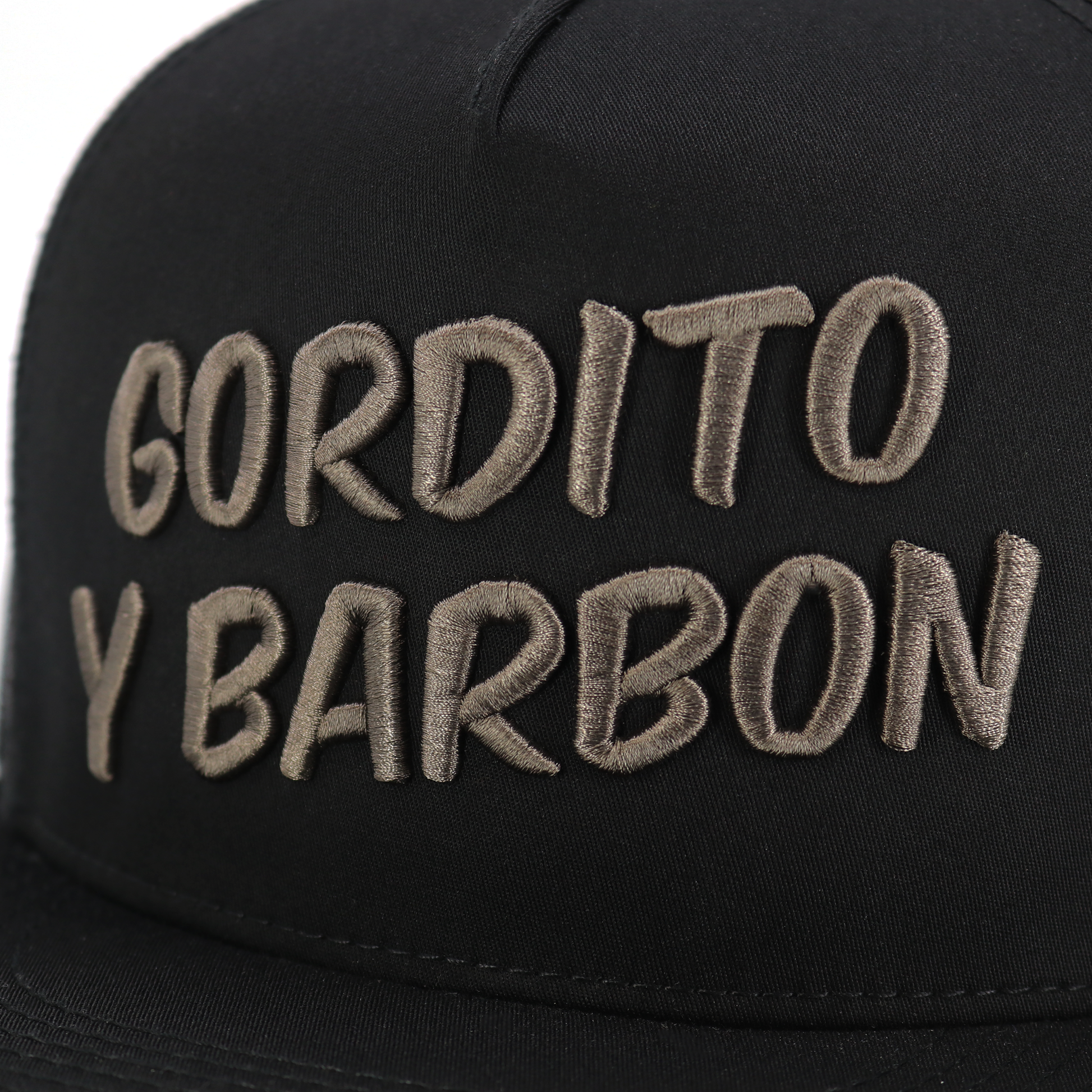 Black Gordito Y Barbon flat visor hat with charcoal embroidered logo, high profile, 5-panel design.