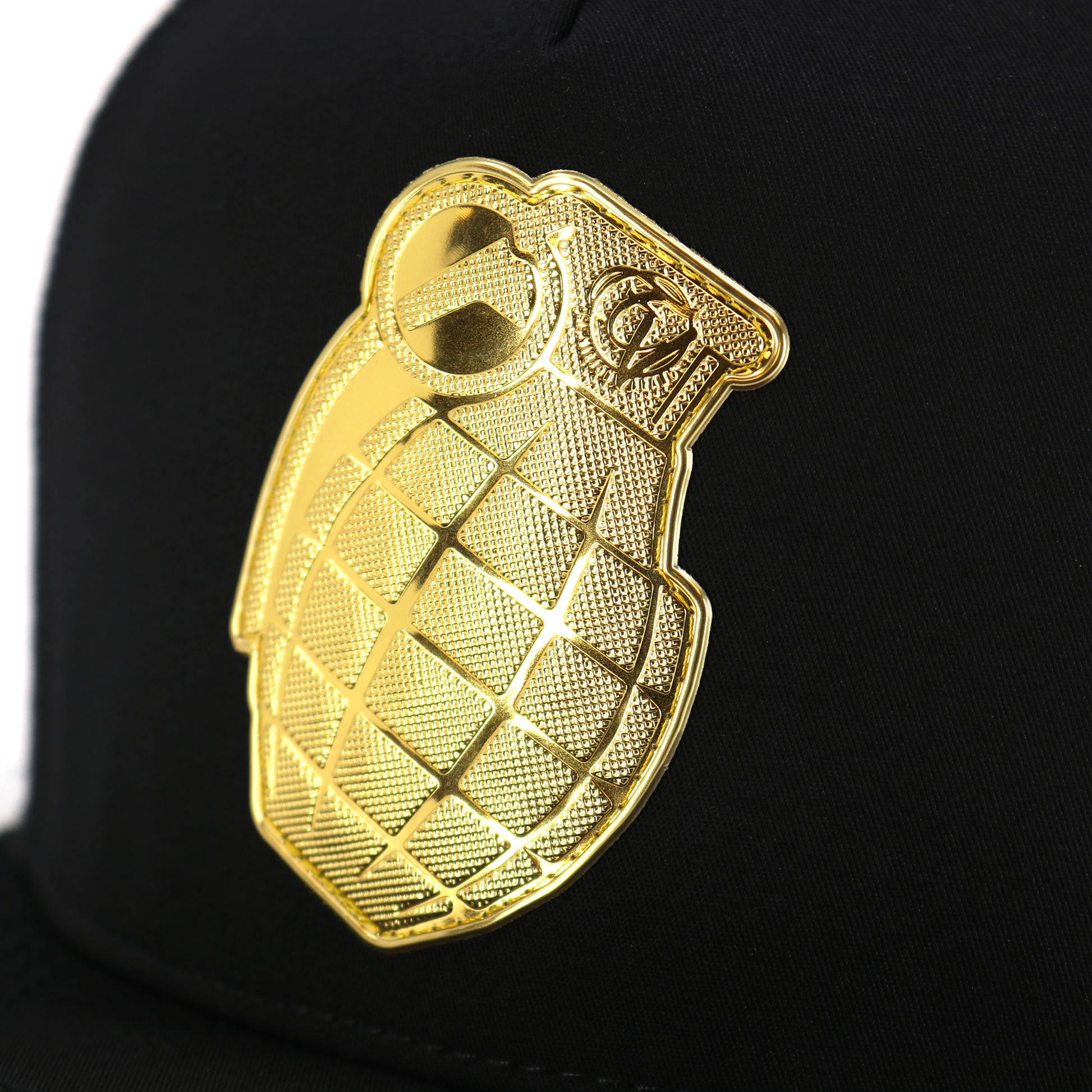 Granada Black flat visor hat with a shiny gold grenade emblem.