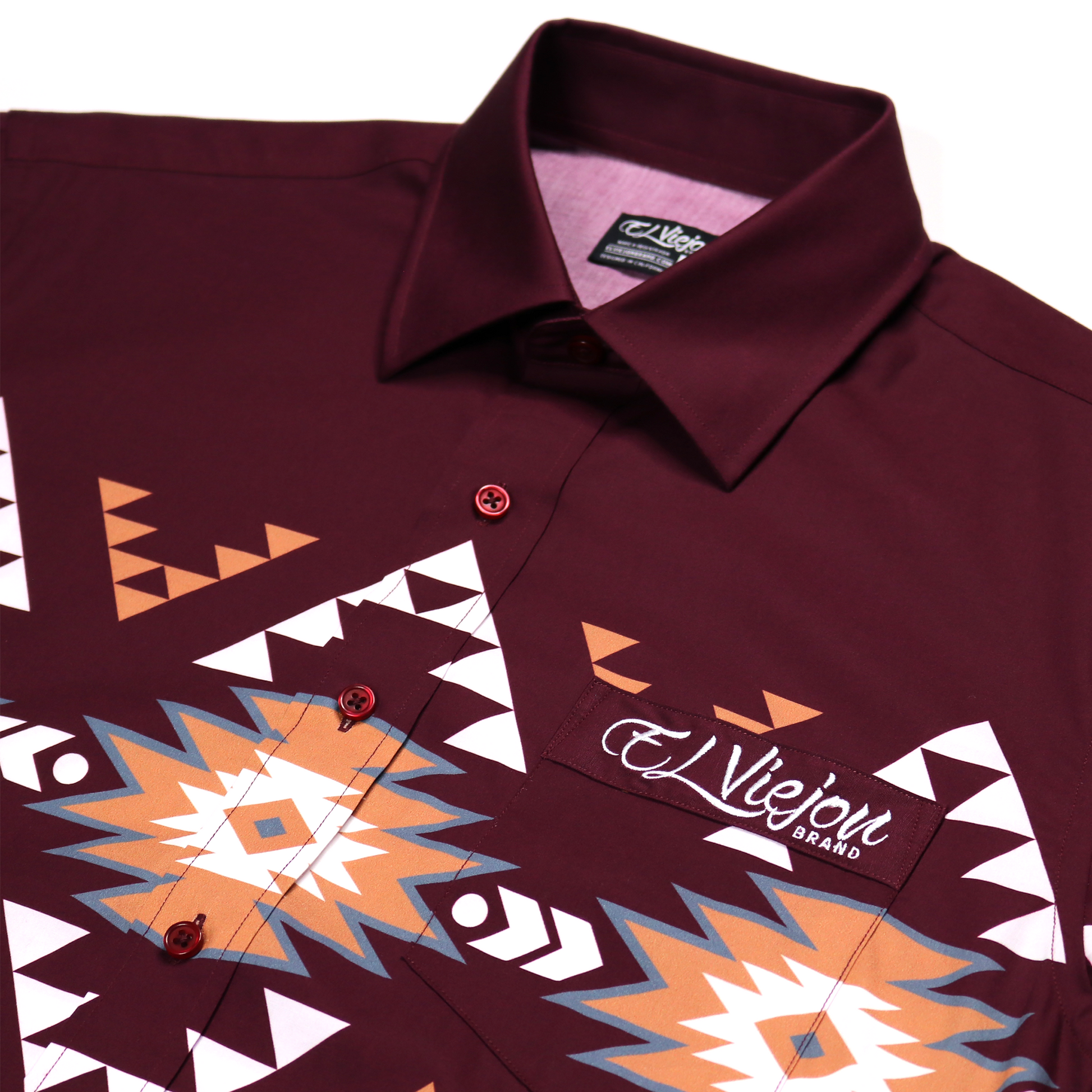 Hidalgo Maroon dress shirt, 100% cotton, with colorful geometric Aztec-inspired patterns and "El Viejon Brand" logo.