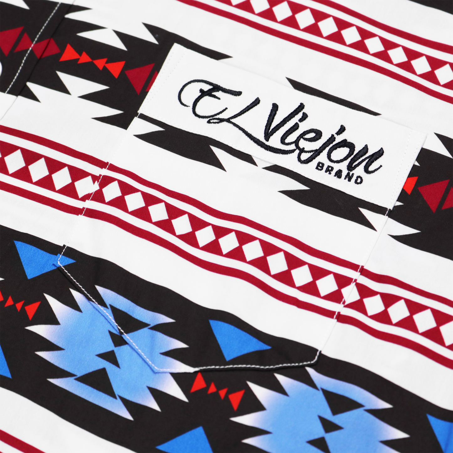 Lakota White dress shirt with embroidered "El Viejon Brand" logo on front pocket and geometric pattern.