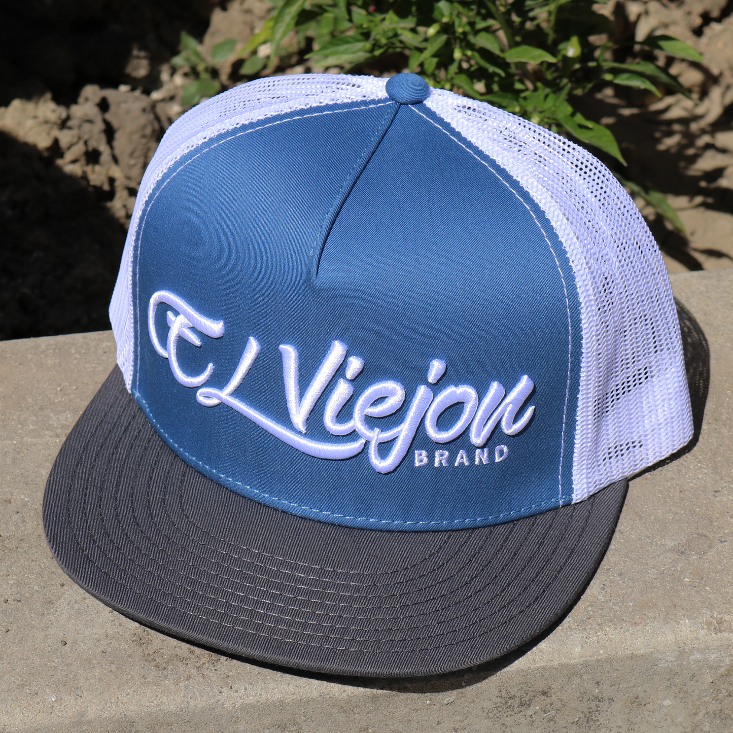 La Original Charcoal/Indigo/White flat visor hat with "El Viejon Brand" embroidered on front.