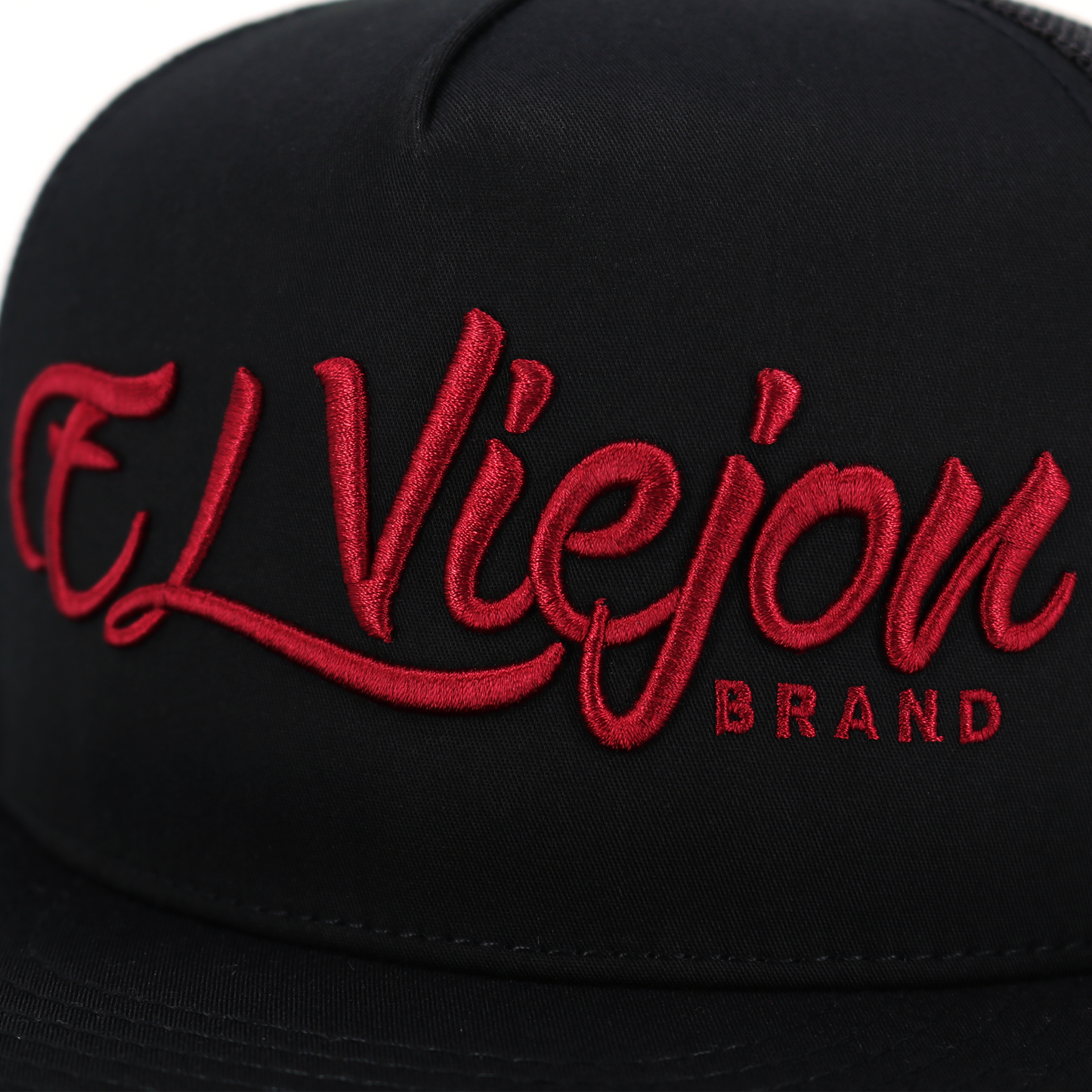 Black flat visor hat with "El Viejon Brand" embroidered in red script.