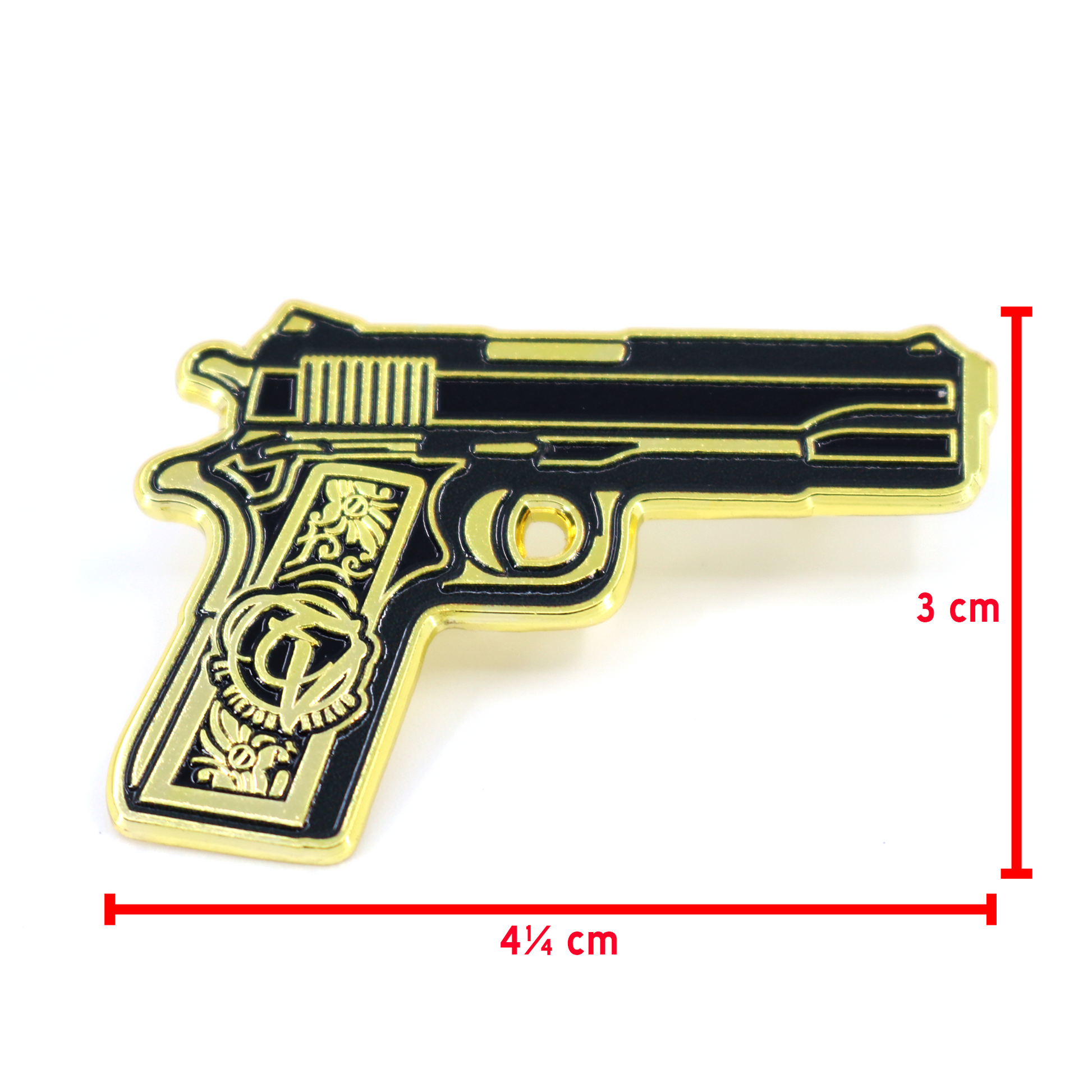 Pin de pistola dorada y negra con cachas de oro, 4¼ cm de largo y 3 cm de alto.