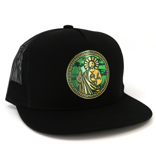 Black San Judas flat visor trucker hat with gold and green circular emblem.