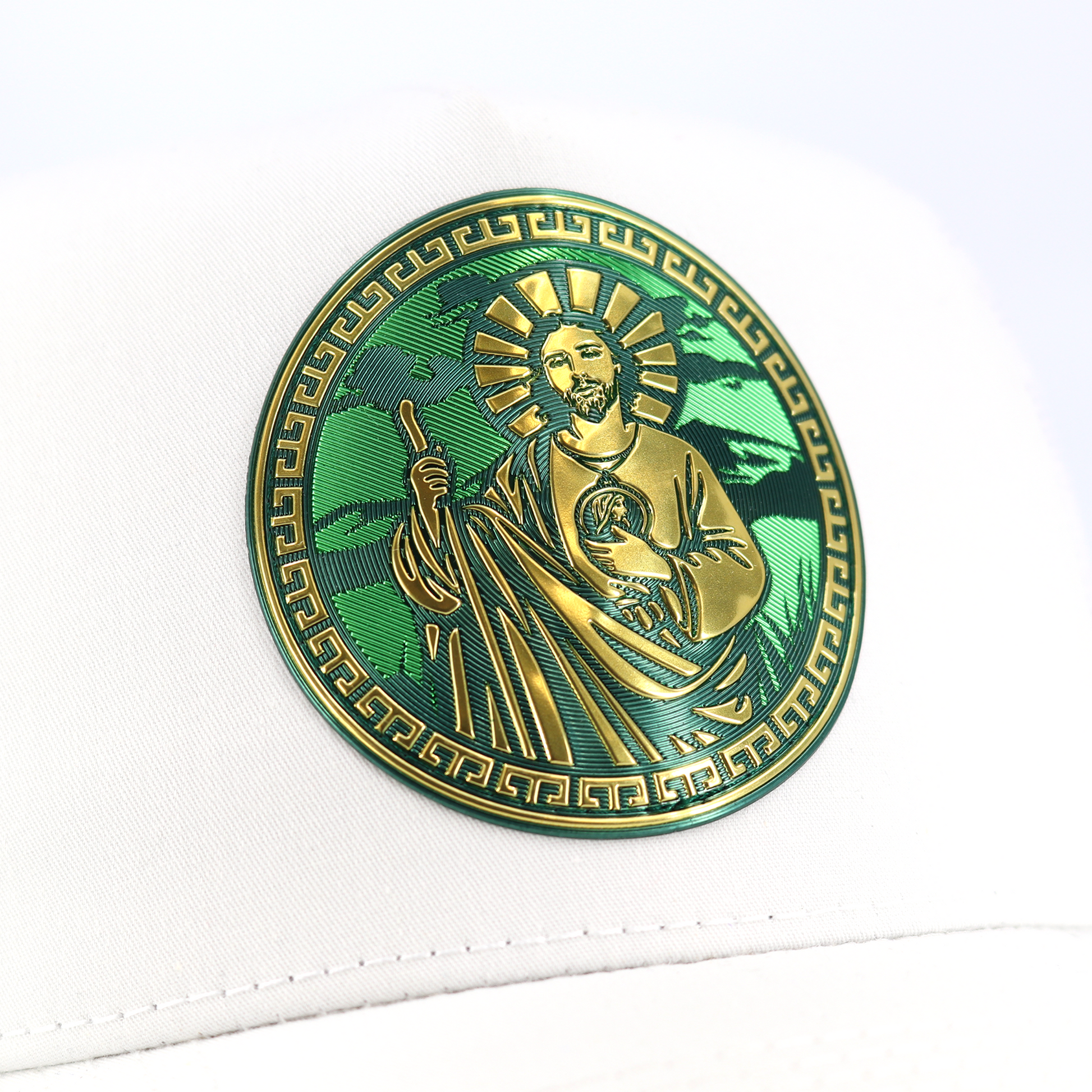 White San Judas AVC hat with a gold and green circular emblem.
