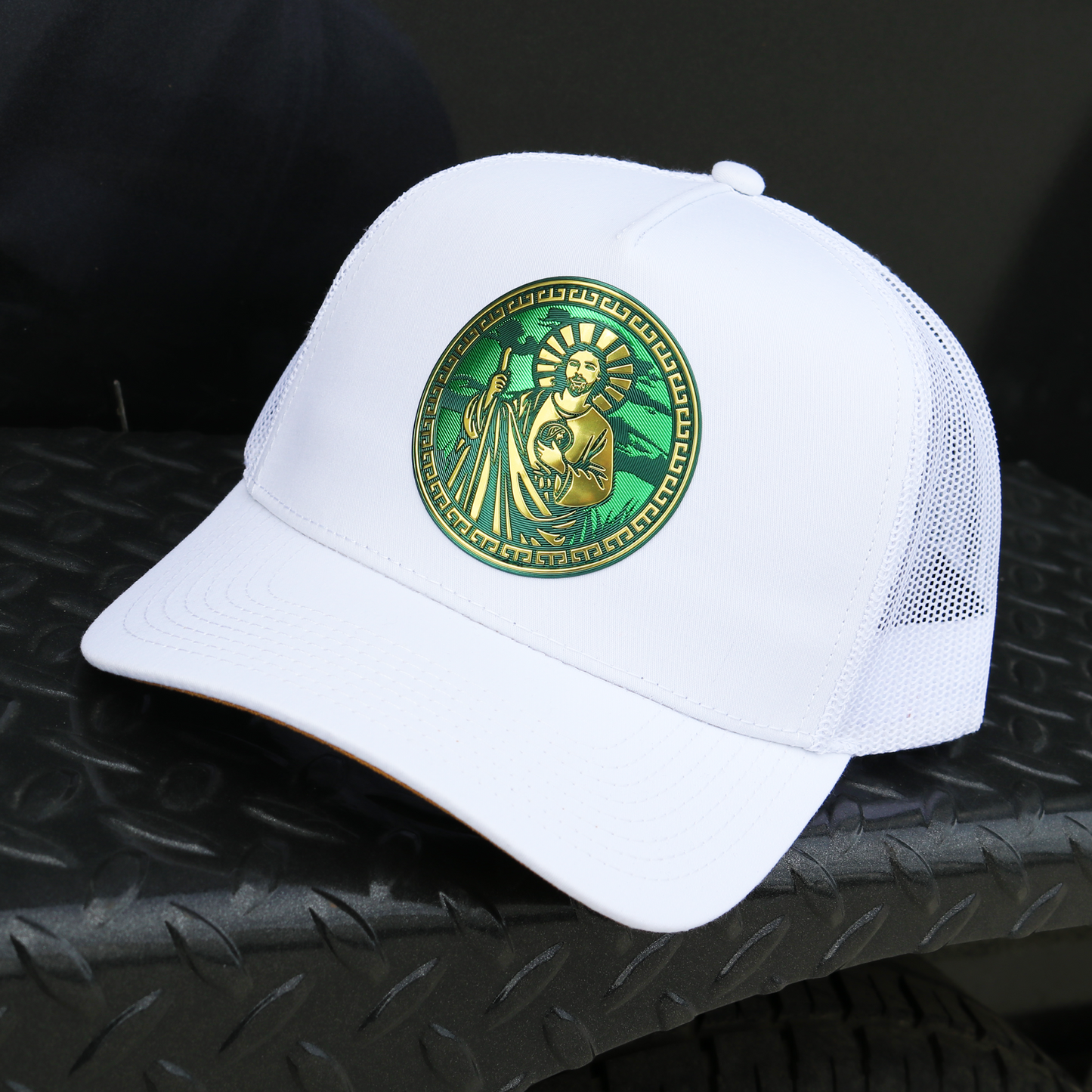 White San Judas AVC hat with a gold and green circular emblem, mesh back, and pre-curved visor.