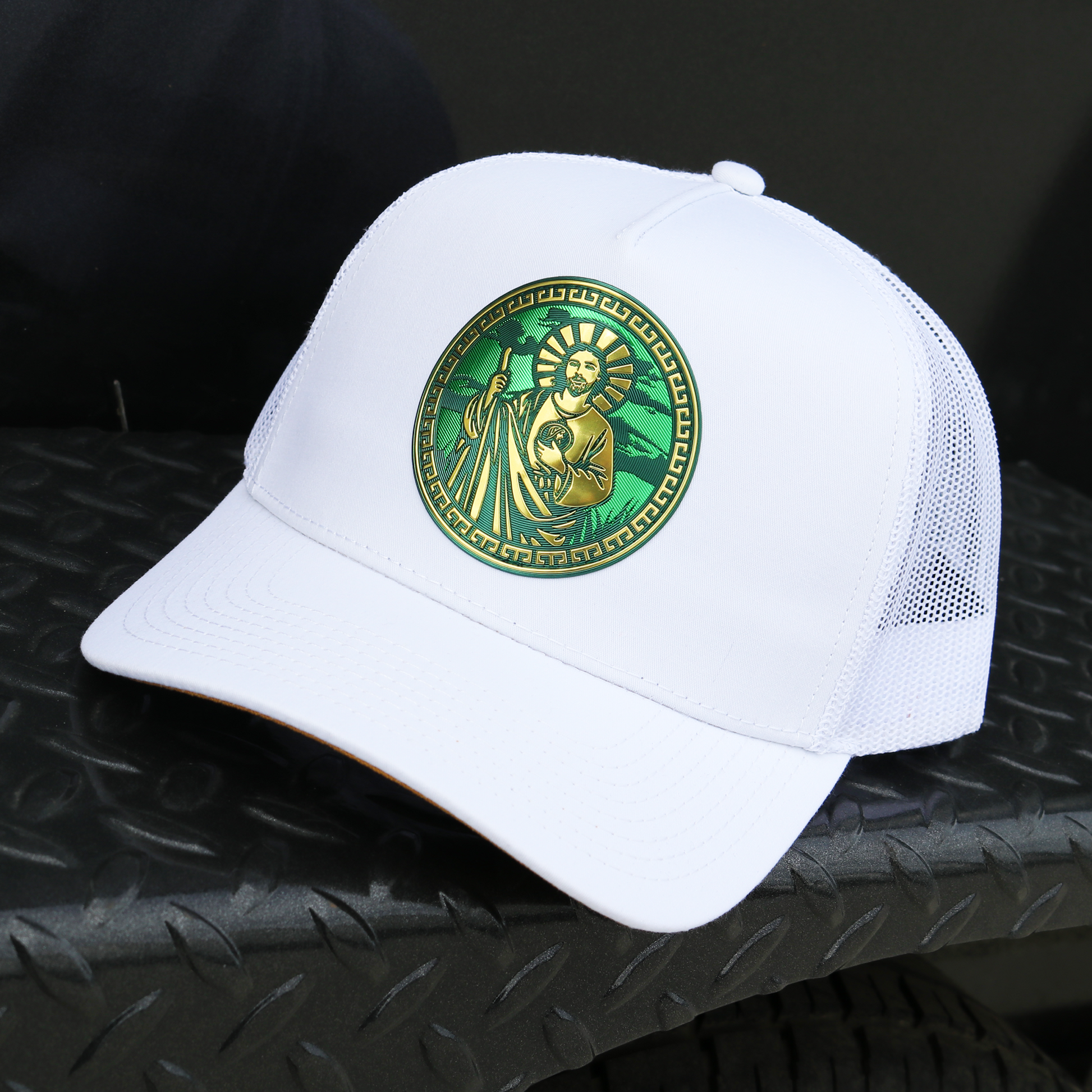White San Judas AVC hat with a gold and green circular emblem, mesh back, and pre-curved visor.