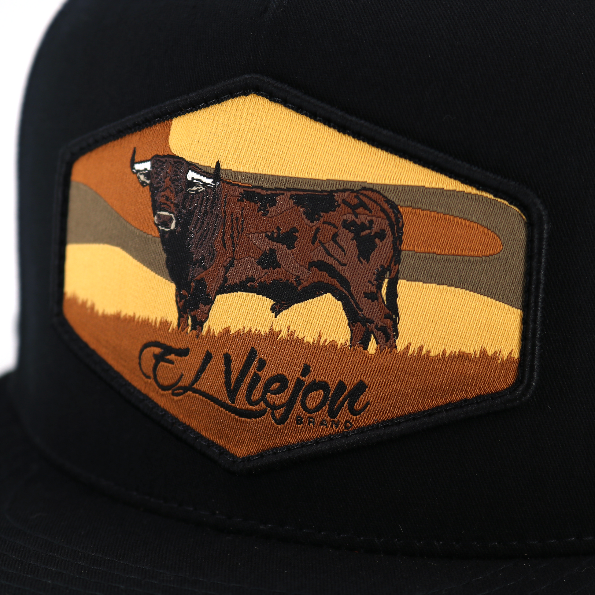 Black Semental flat visor trucker hat with hexagonal bull patch and "El Viejon Brand" text.