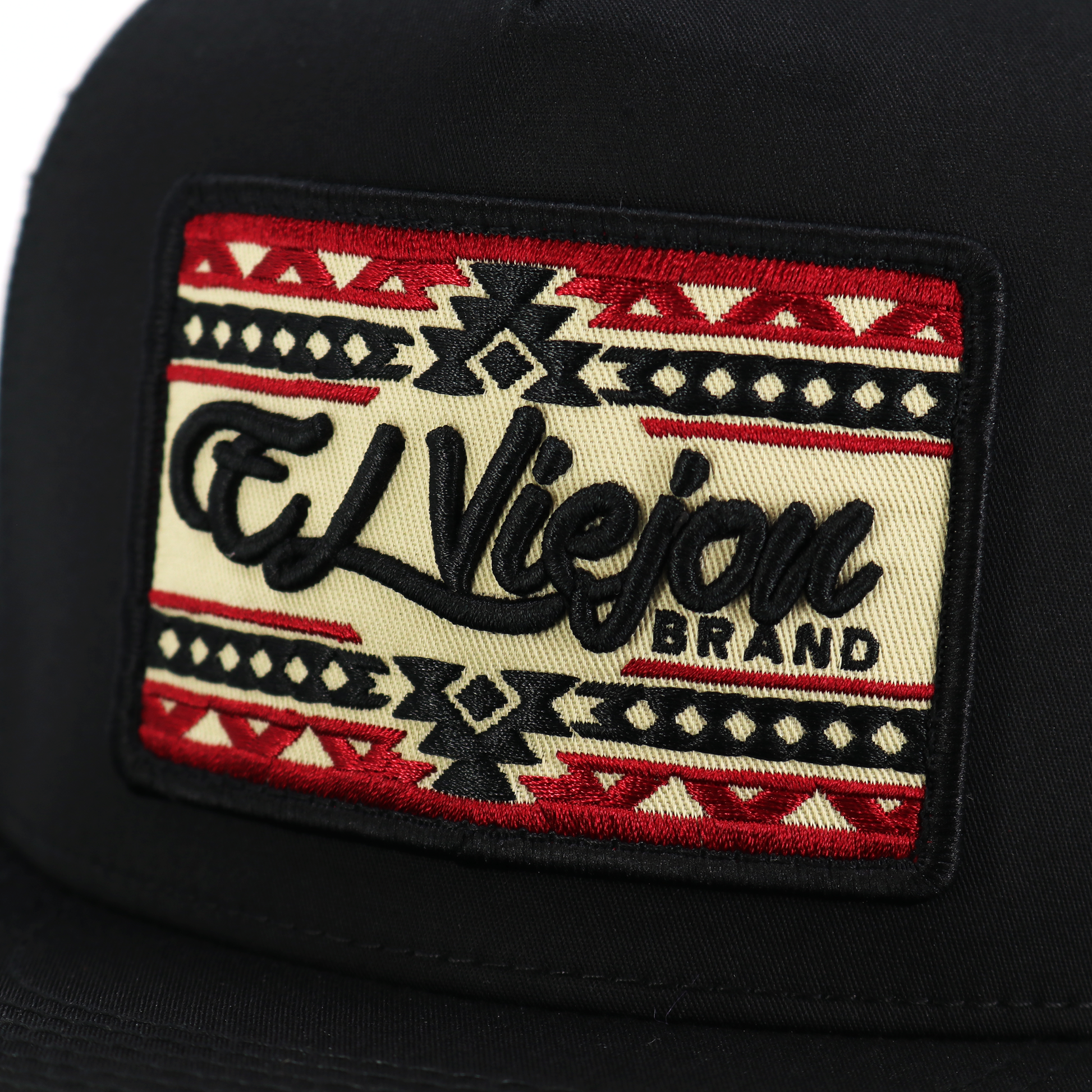 Sonoma Black flat visor hat with "El Viejon Brand" embroidered patch, featuring red, black, and tan Aztec patterns.