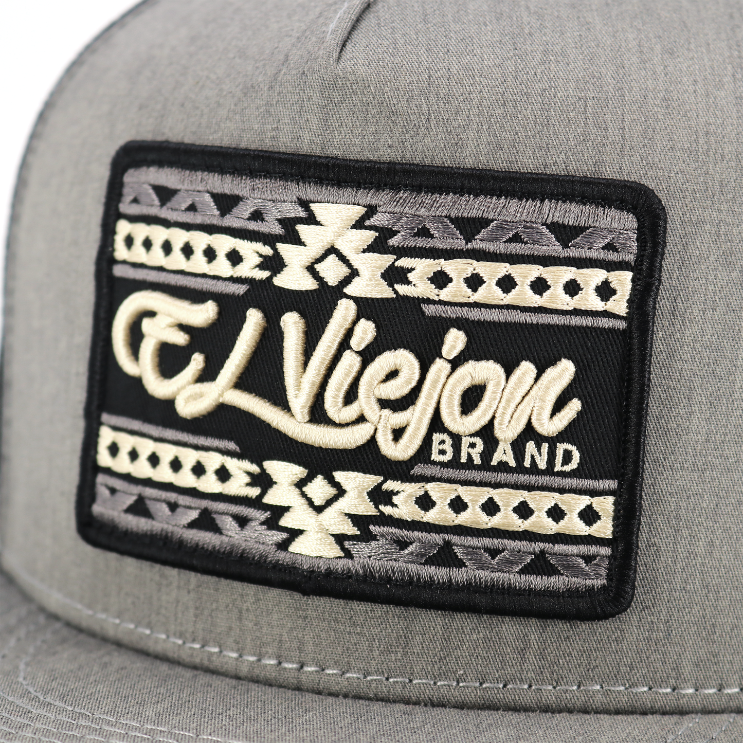 Sonoma heather/black flat visor hat with "El Viejon Brand" embroidered patch and tribal pattern.